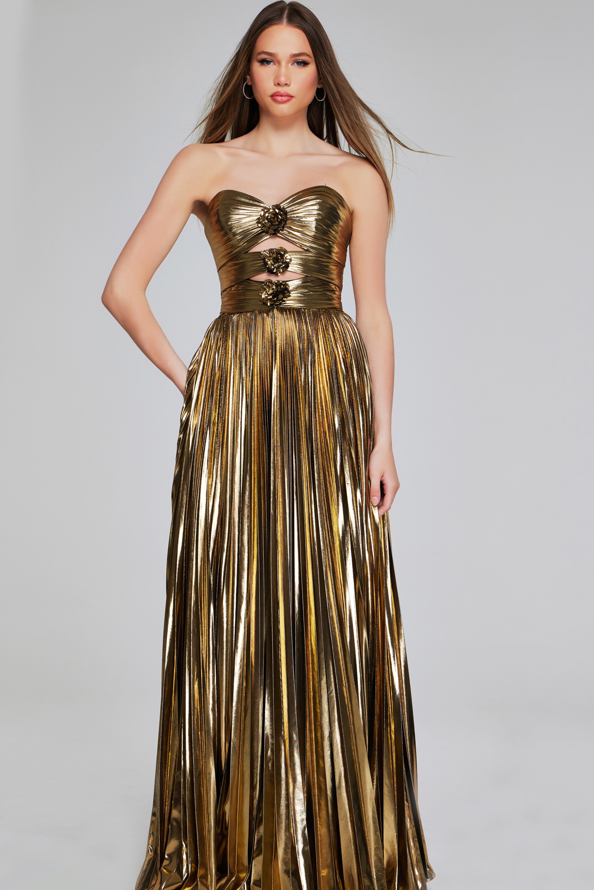 Front view of Jovani 42335 gold gown with flowing skirt and floral accents.