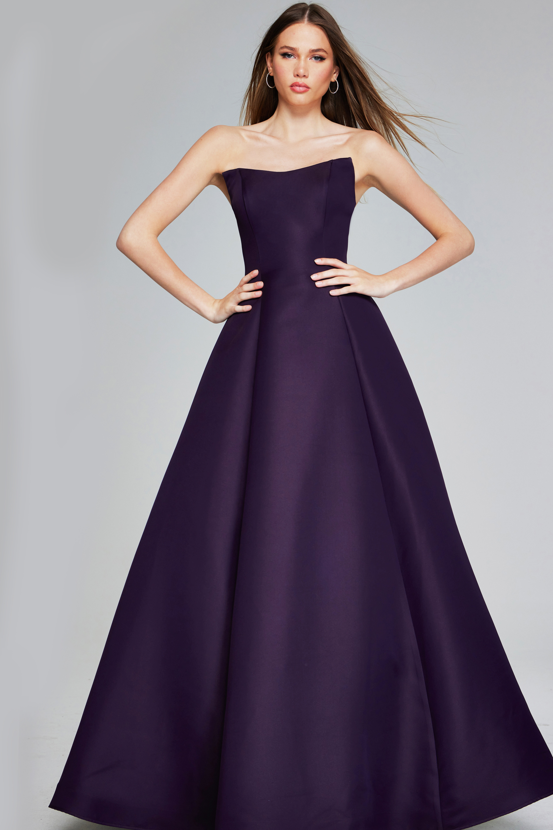 Model wearing Jovani 42347 purple strapless A-line evening gown, front view