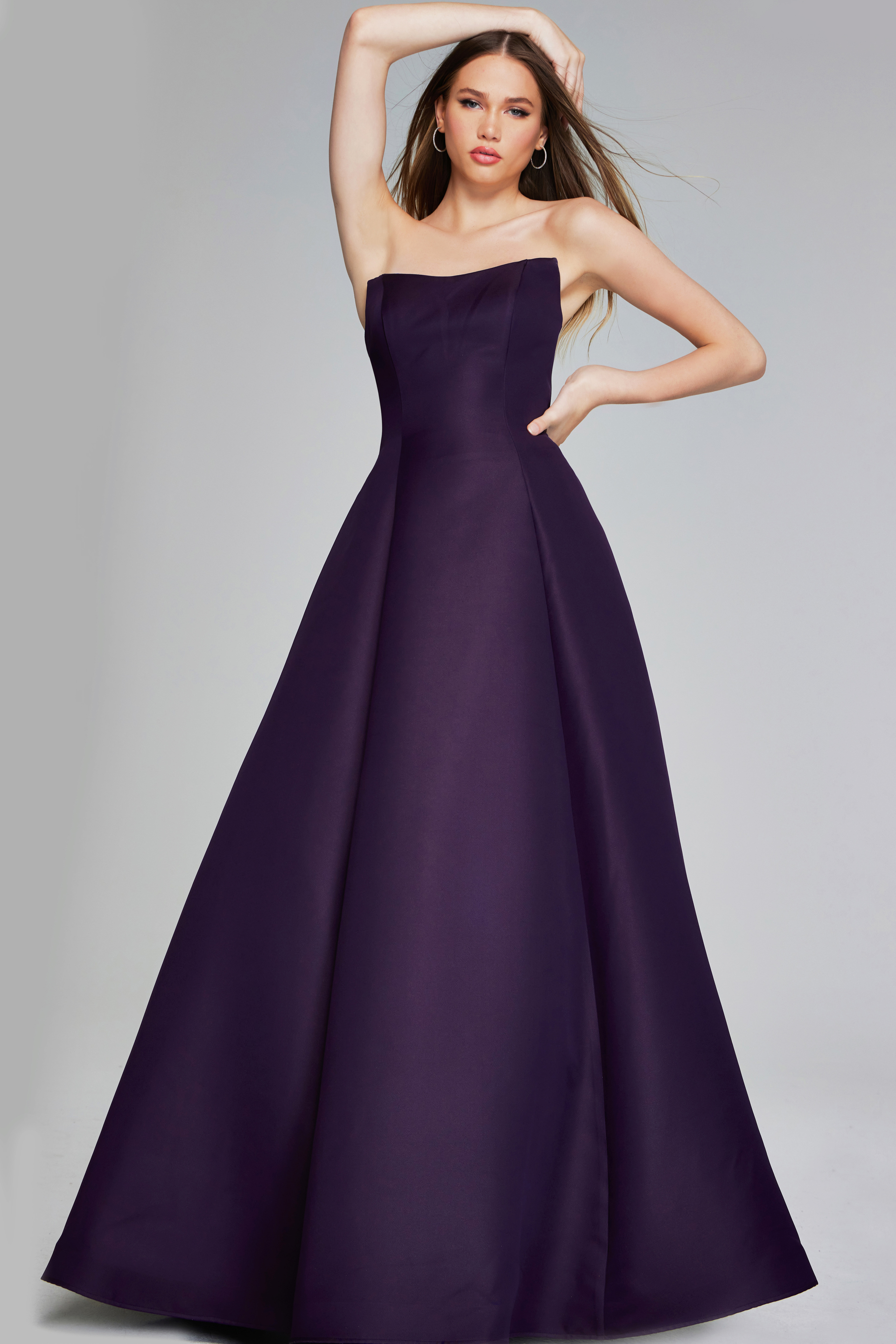 Model wearing Jovani 42347 purple strapless A-line evening gown, full front pose