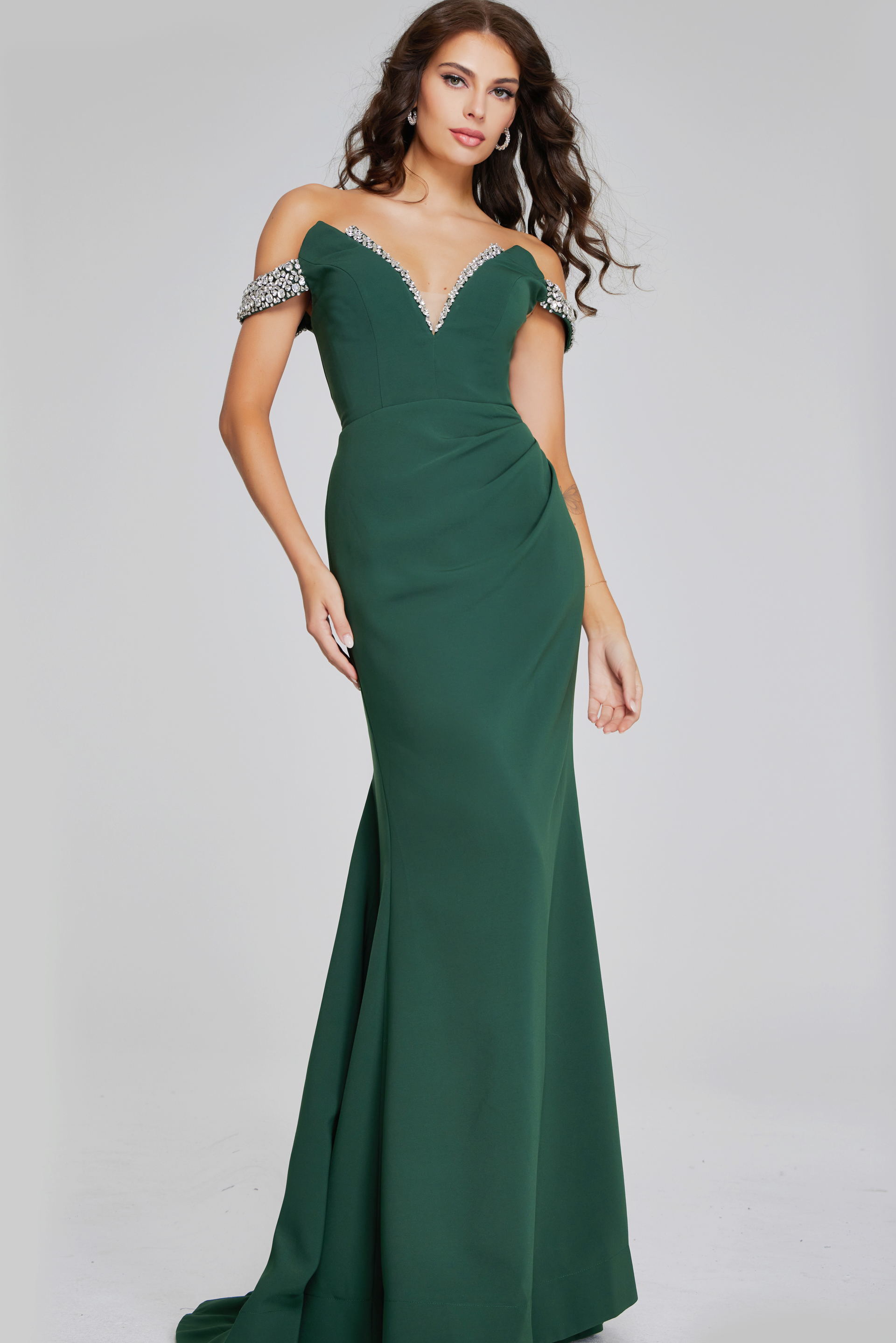 Model wearing Jovani 42394 floor-length green gown with beaded off-the-shoulder neckline from the front.