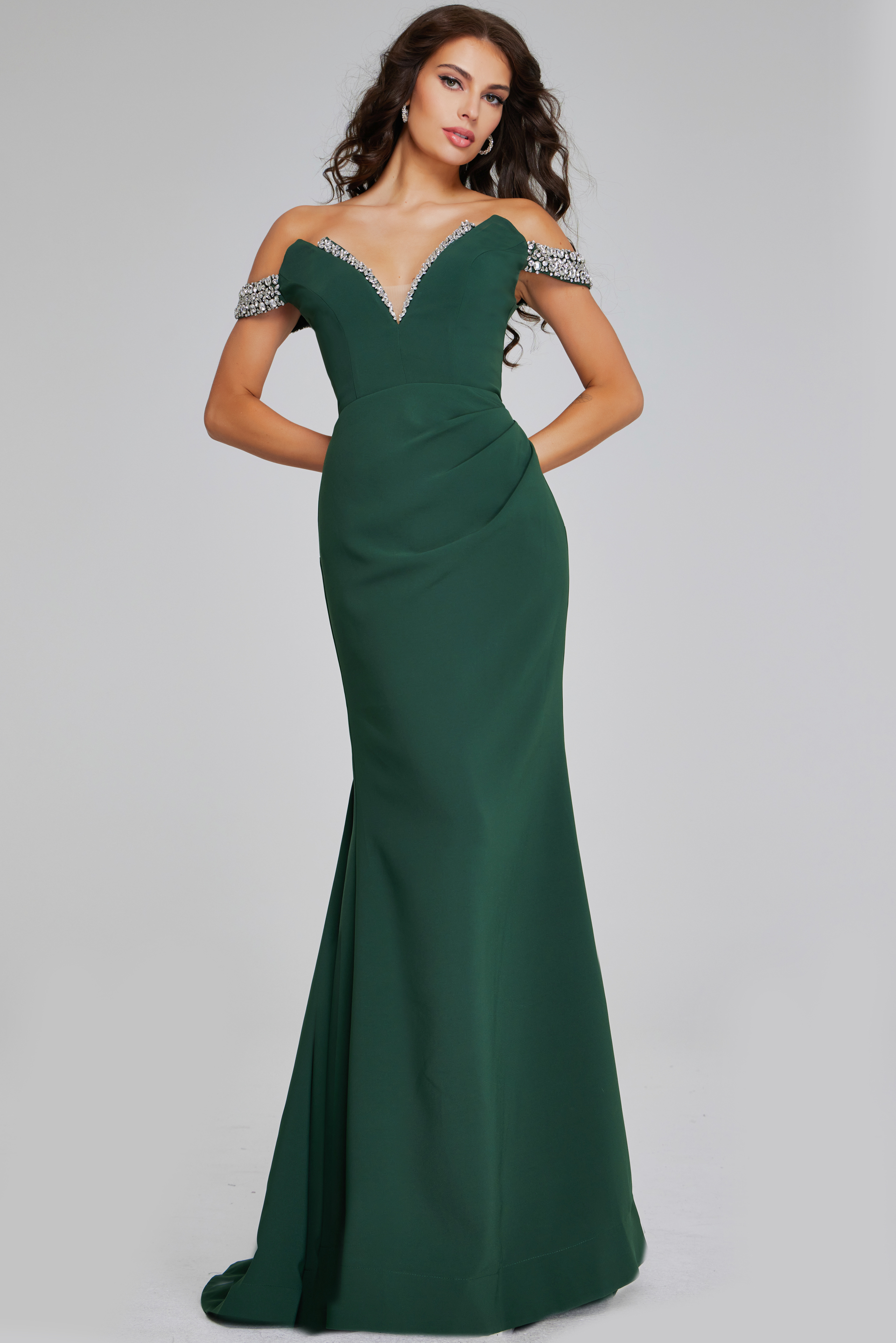 Model wearing Jovani 42394 green gown with beaded neckline from the front.