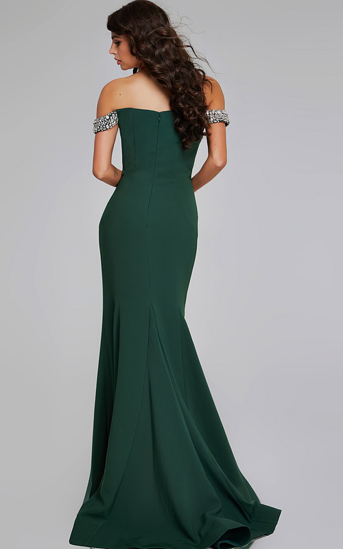 Model showing the back of Jovani 42394 green gown with a subtle flared skirt.