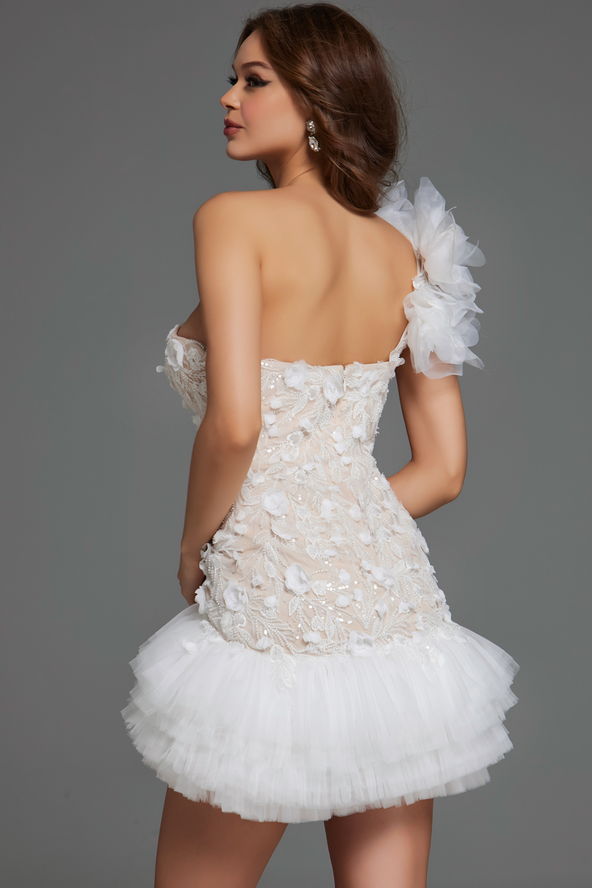 Model wearing Jovani 42536 dress in ivory, back view with intricate floral design.