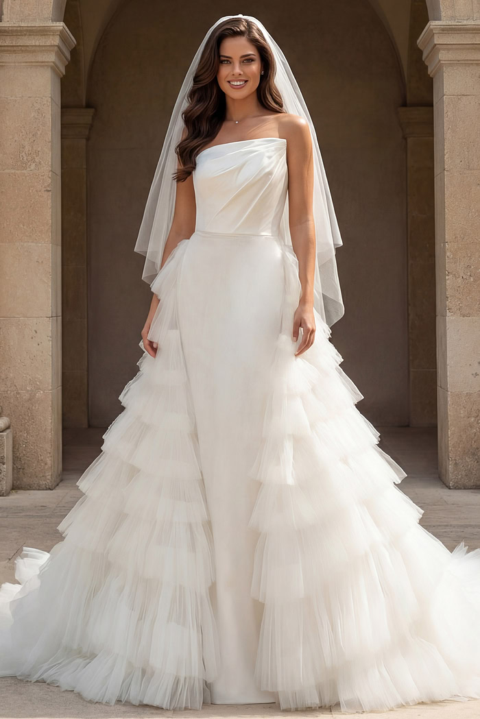 Front view of strapless bridal gown with dramatic layered tulle skirt