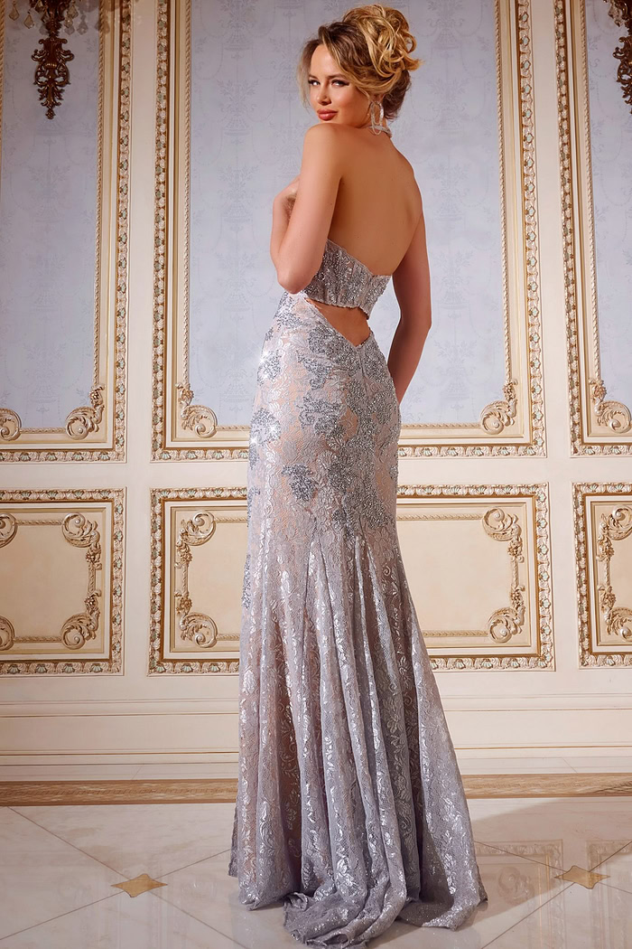 Model in Jovani 43098 gown showing open back and lace detailing, back view.