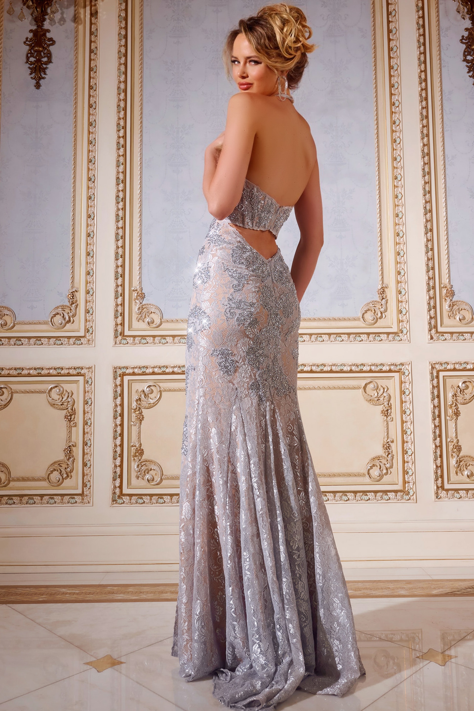 Model in Jovani 43098 gown showing open back and lace detailing, back view.