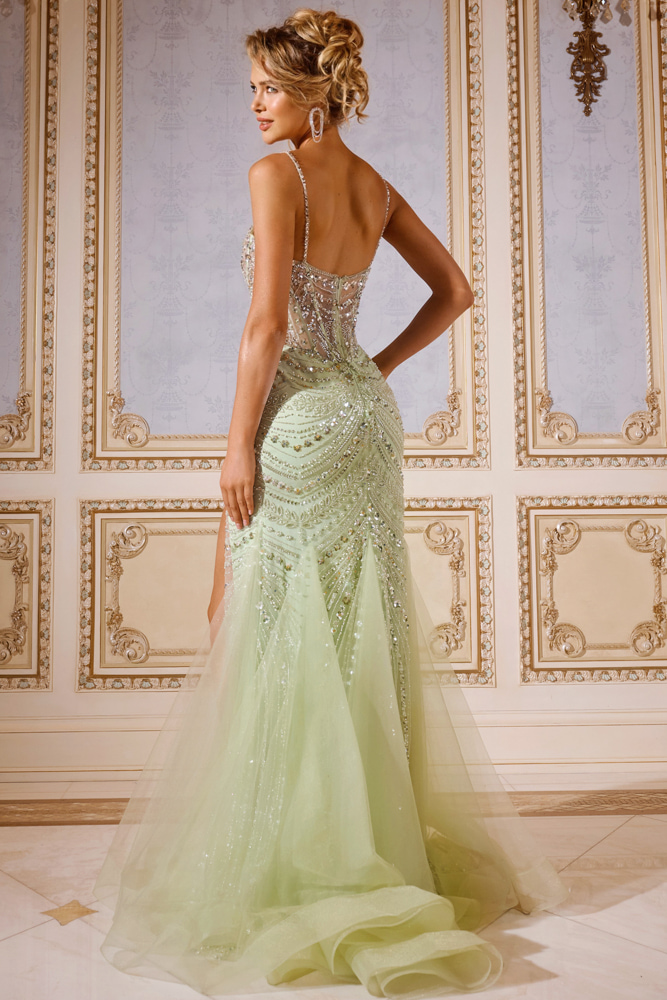 Model wearing Jovani 43189 green gown showing intricate back details and flowing silhouette.