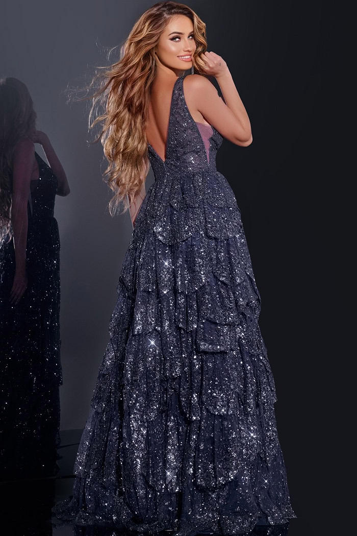 Model showcasing the back of Jovani 43198 navy blue tiered sequined gown