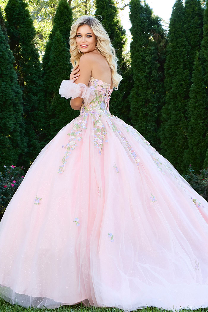 Back view of model wearing Jovani 43231 lilac ball gown showing floral appliqués.