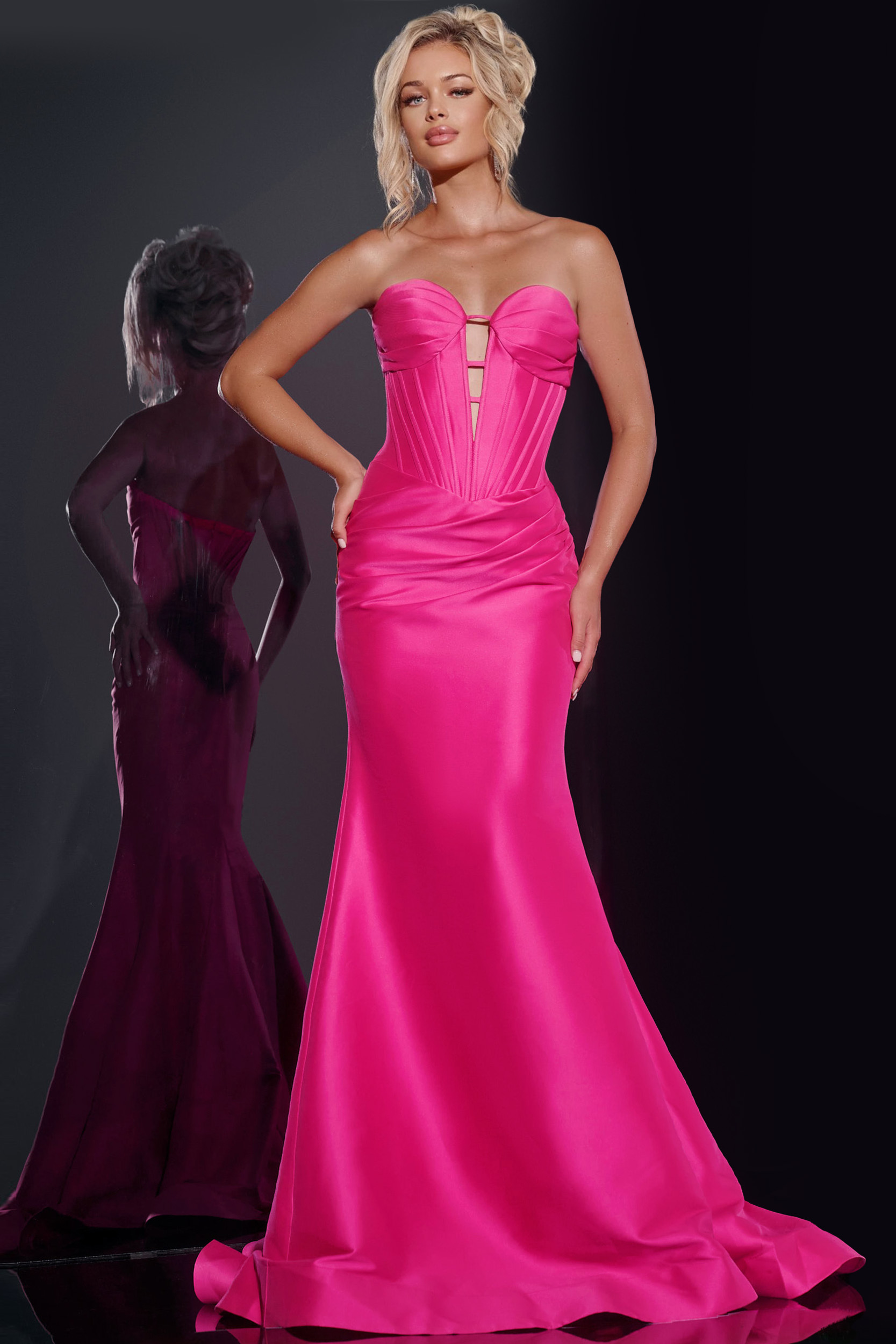 Model wearing Jovani 43350 fuchsia gown with a strapless neckline and mermaid silhouette, front view.