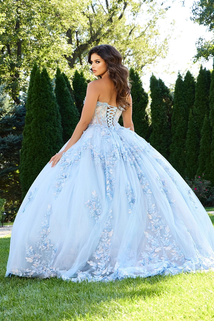 Model wearing Jovani 43433 blue ball gown with lace-up back, back view.