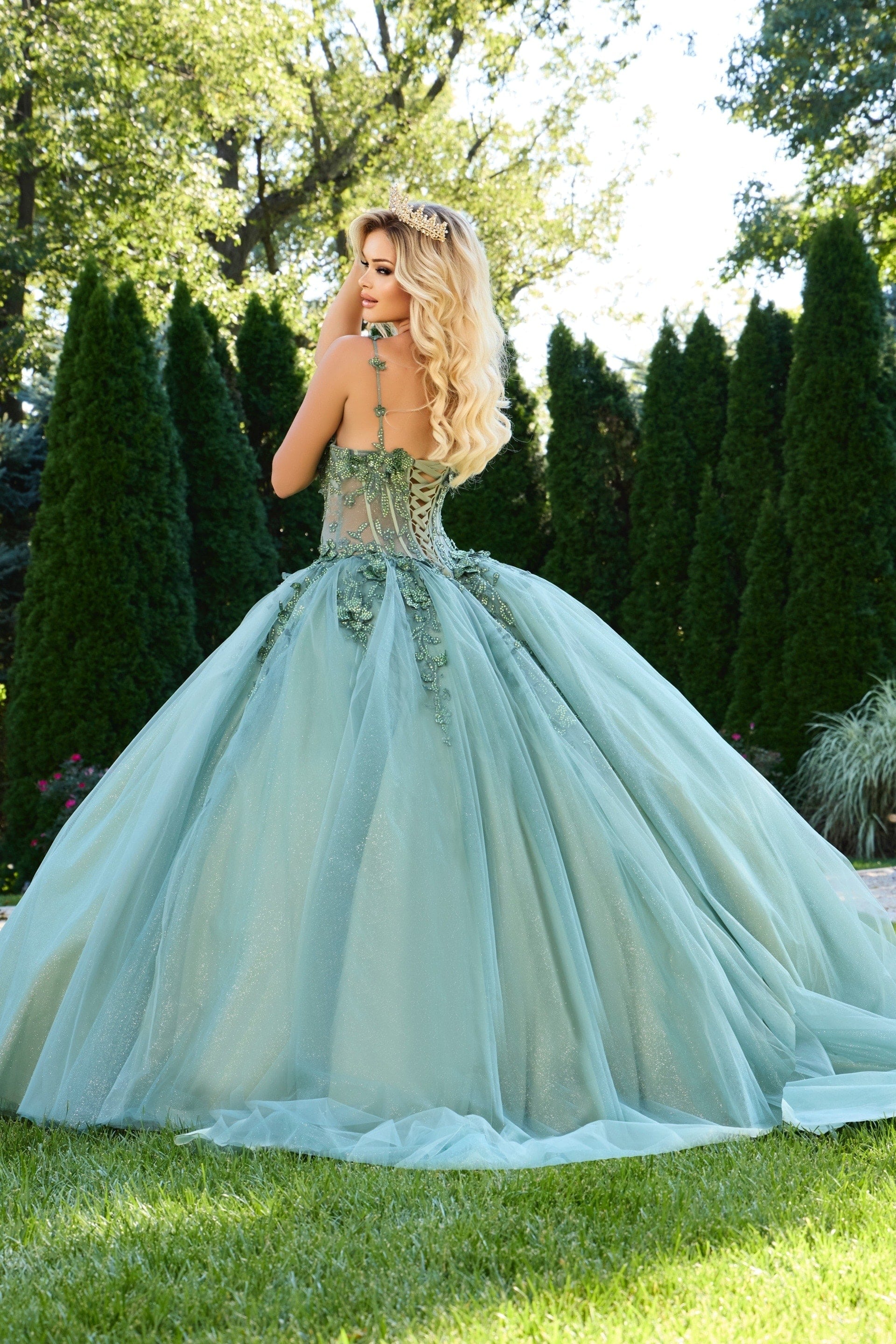back view of model wearing 43437 green ball gown with lace-up design