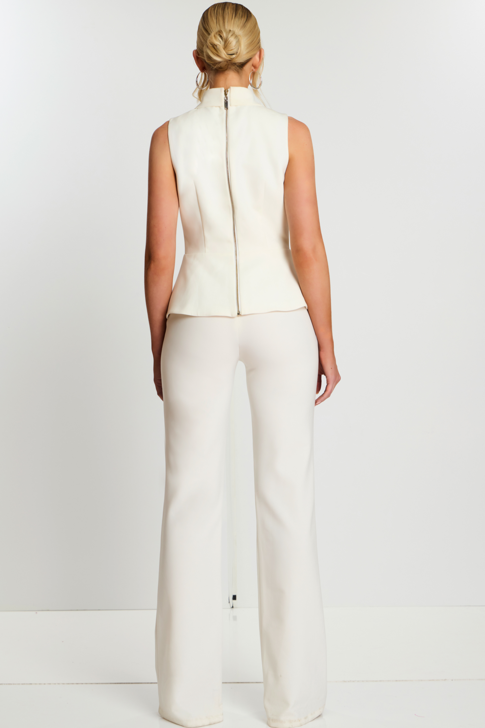 Back View Of Ivory Button-Up Pant Suit Featuring Long Zipper And Fitted Waist