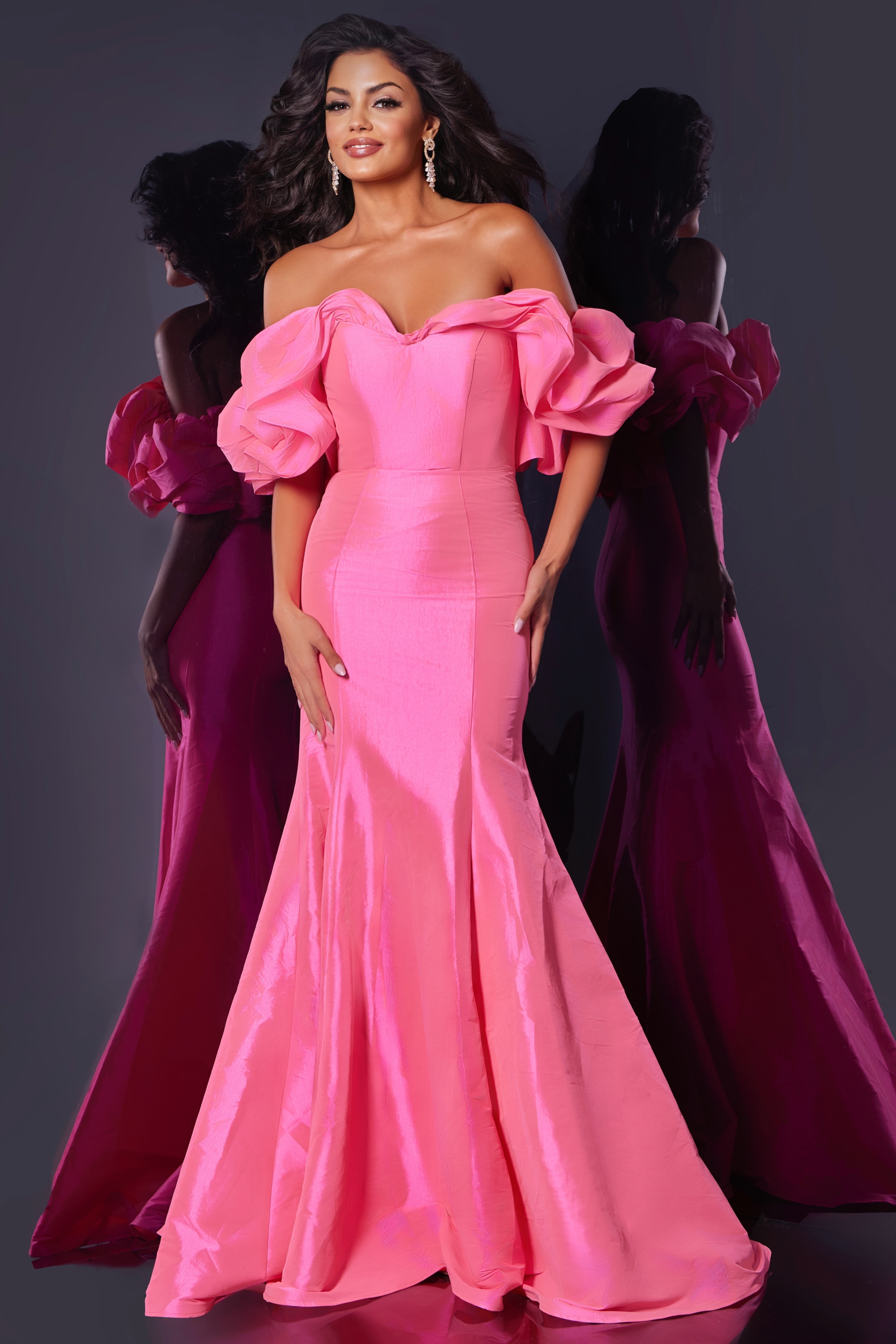 Front view of model wearing Jovani 44271, pink mermaid silhouette gown with off-the-shoulder ruffled sleeves.