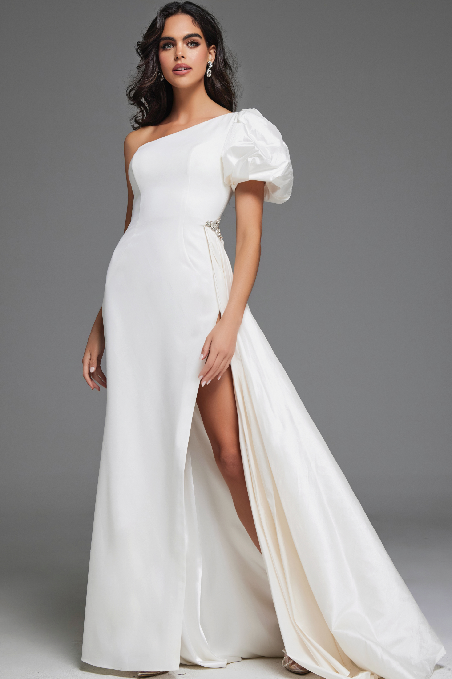 model wearing Jovani 44299 white one-shoulder gown front view with slit