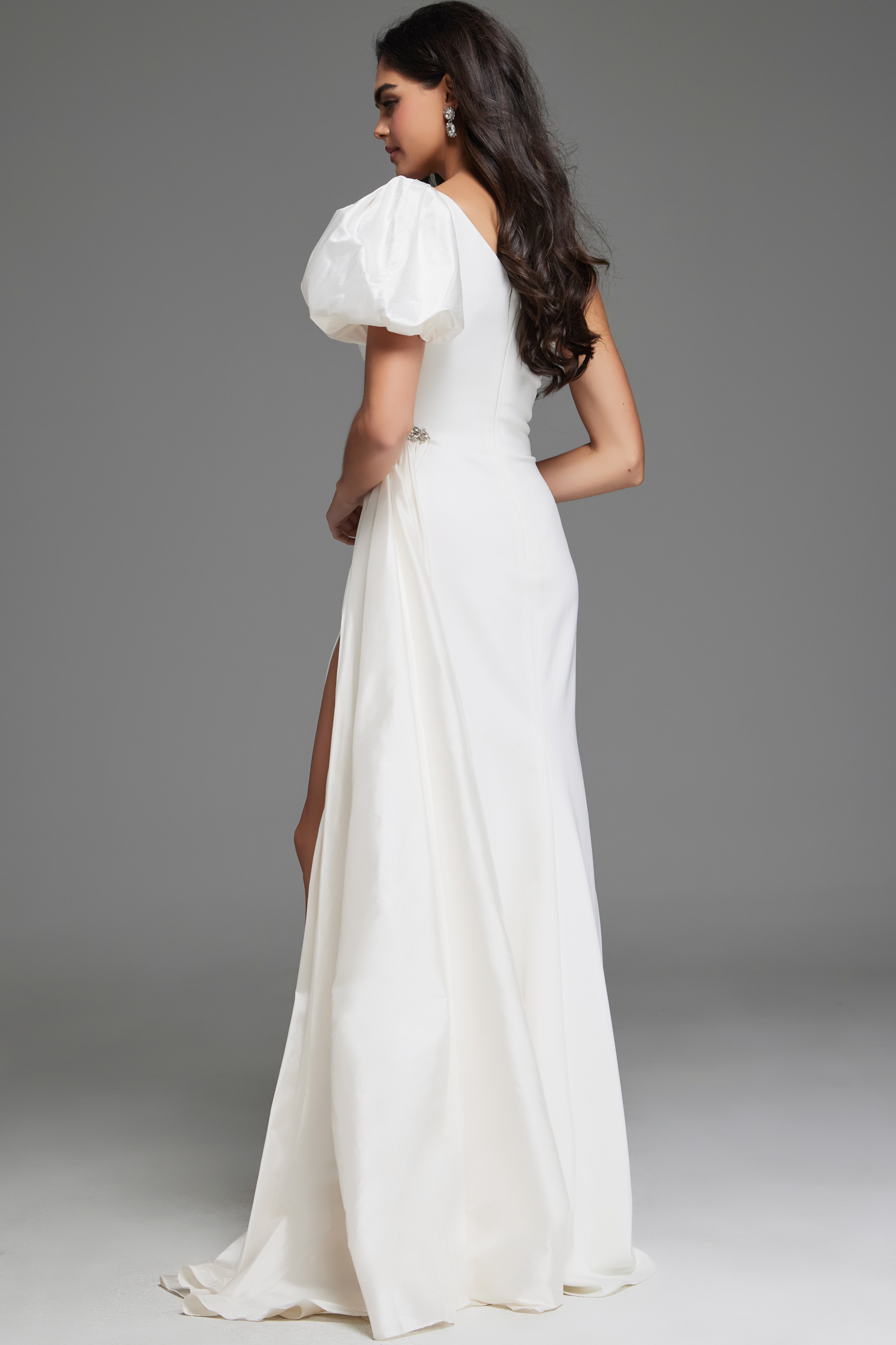 model wearing Jovani 44299 white one-shoulder gown back view