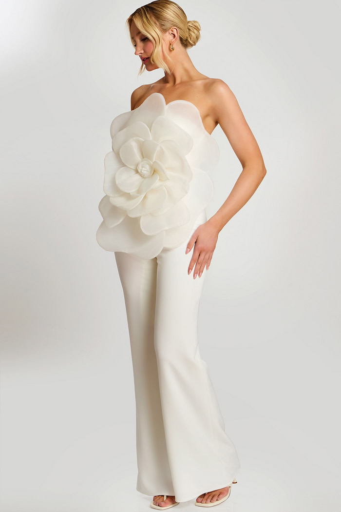 Woman wearing off-white strapless jumpsuit with large floral applique