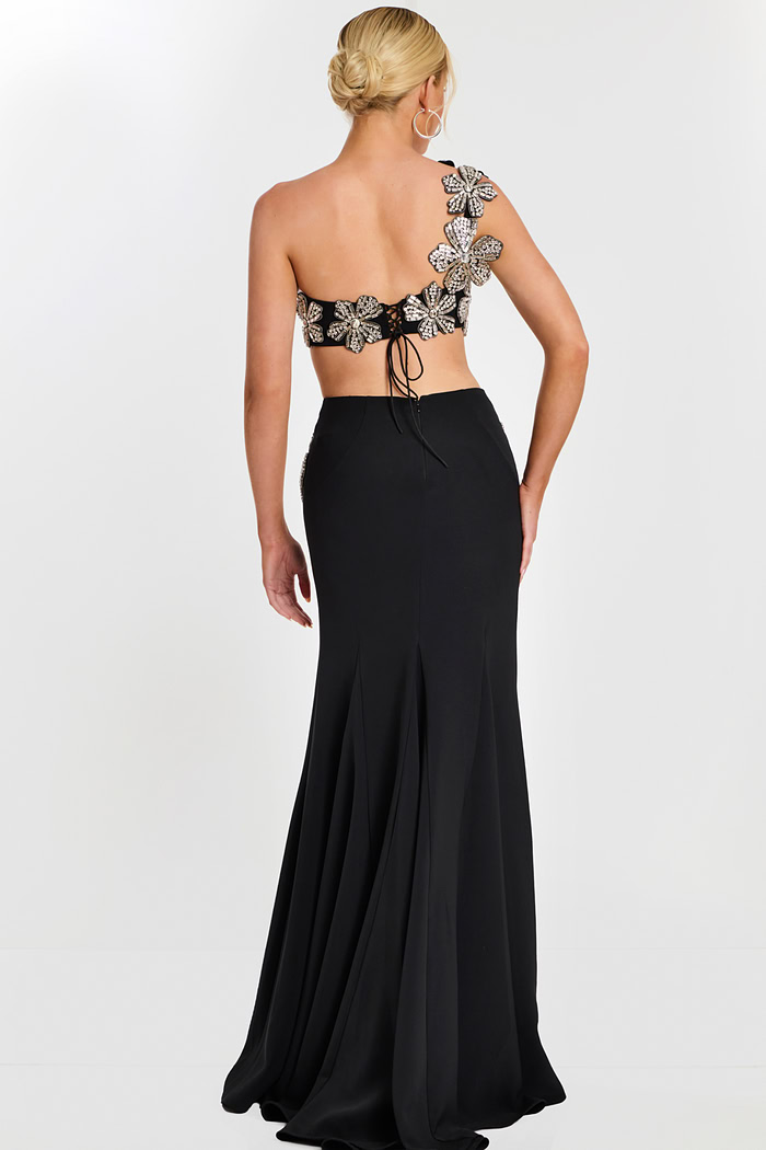 Back view of black skirt and floral lace-up crop top with flower appliqués