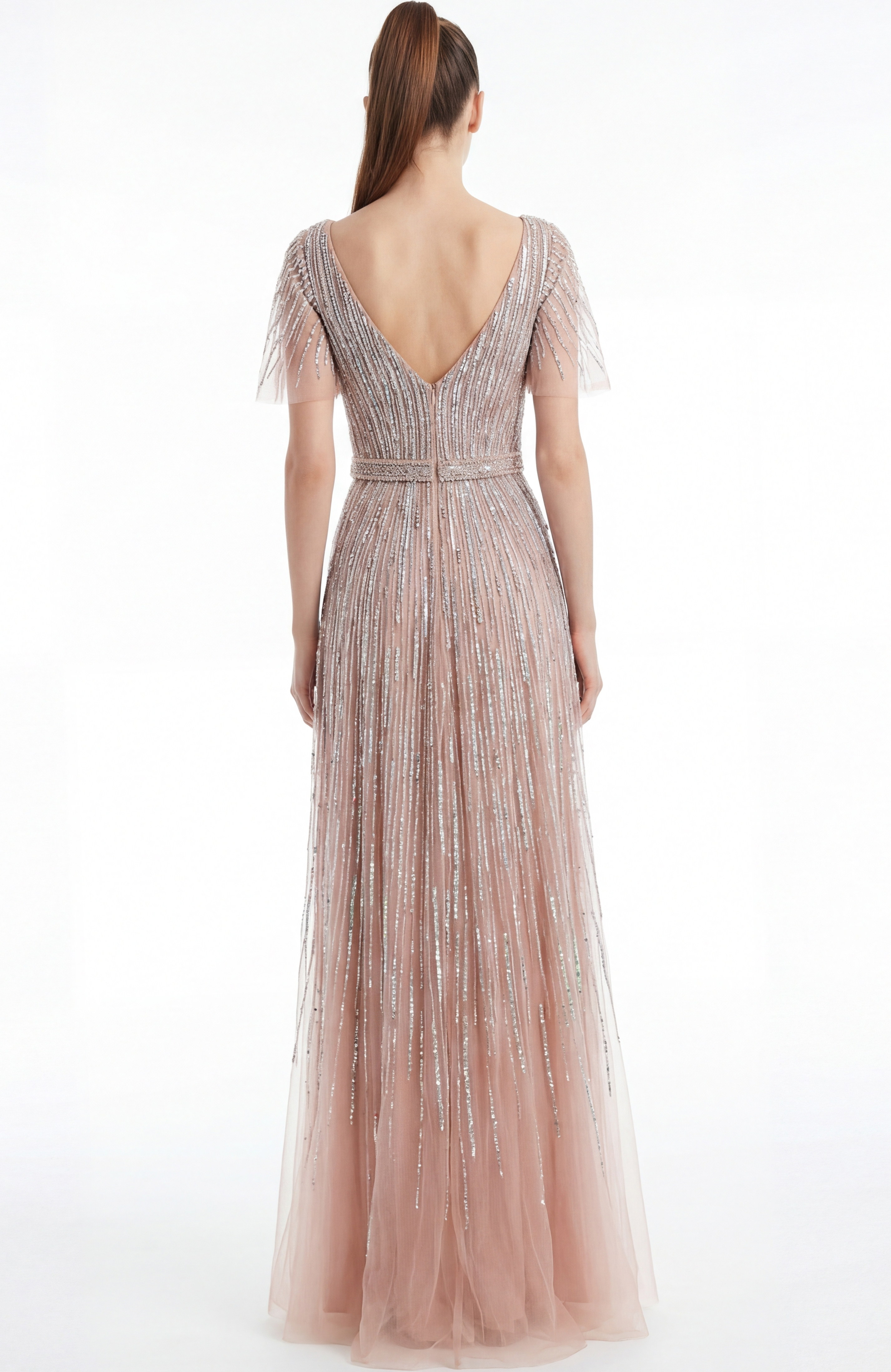 Back view of a beaded A line gown with V back and soft floor length silhouette
