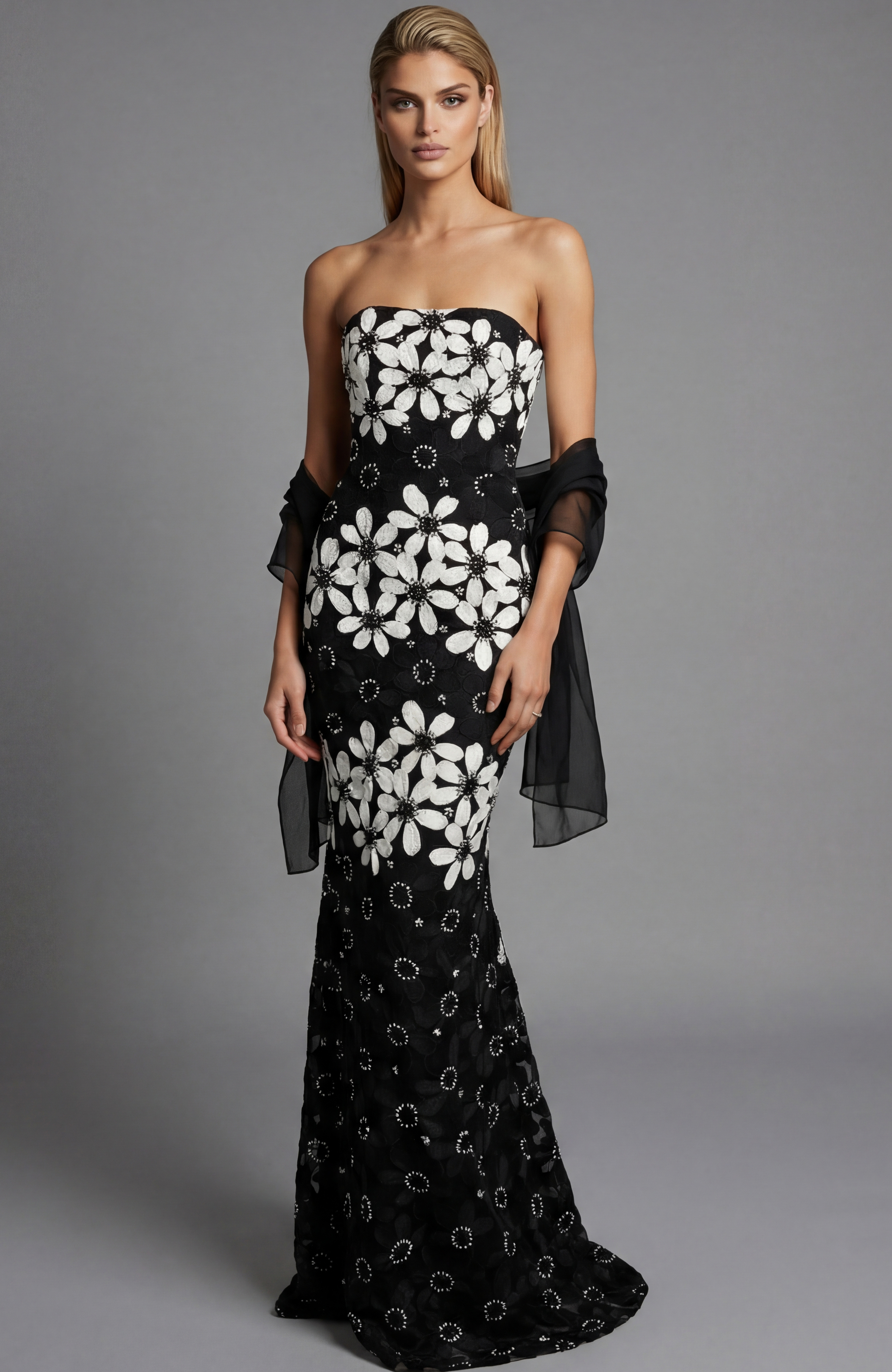 Front view of a strapless black floral brocade column gown