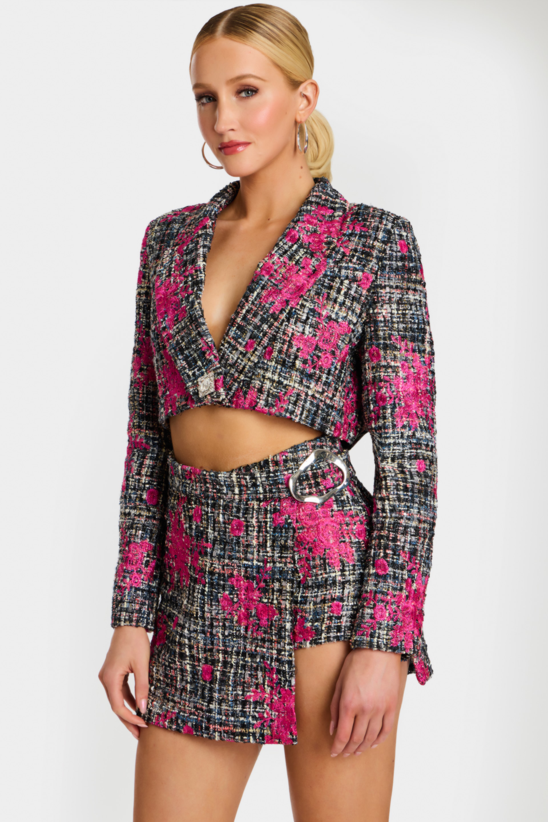 Detail shot of floral tweed fabric and silver buckle on skirt waist