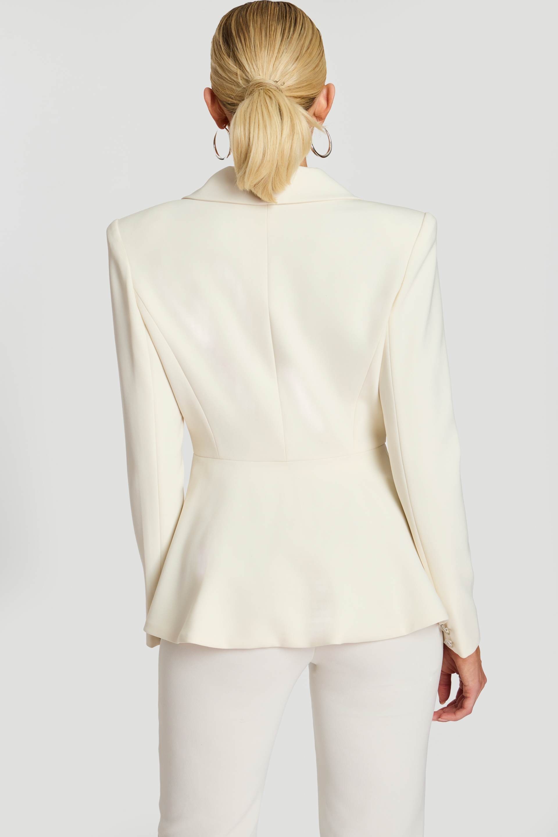 Back view of off-white blazer with fitted waist and soft flared hem