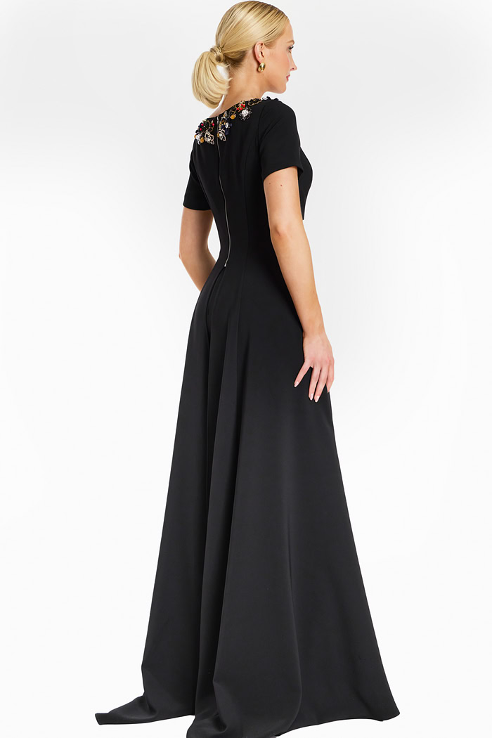 Back view of black jumpsuit showing zipper closure and flared legs