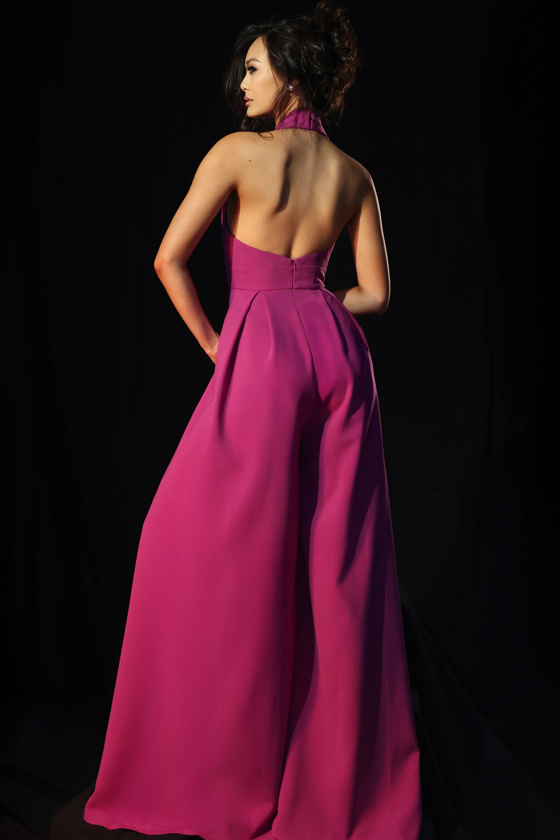 Stylish pink halter jumpsuit with deep neckline and side pockets