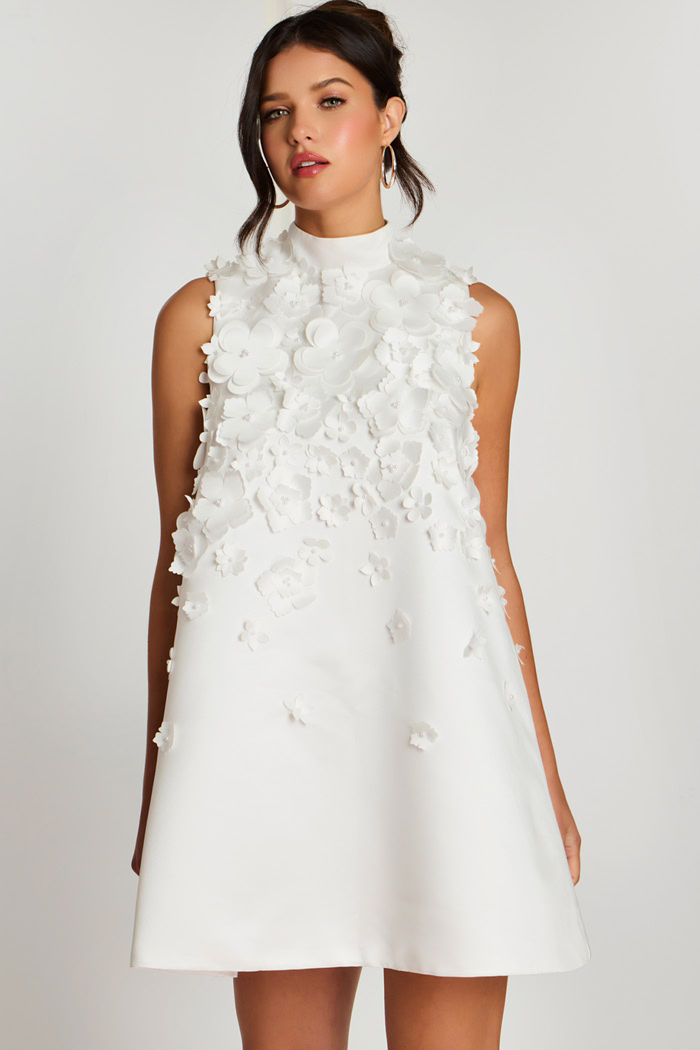 Close-up of high neckline and layered flower details on white satin dress