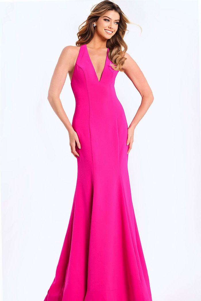 Hot pink halter prom dress with plunging neckline and bow back detail
