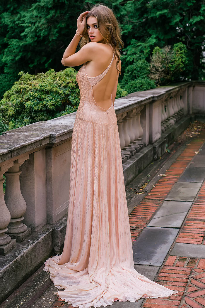 Model seated in Jovani 47780 beige gown with shimmering details