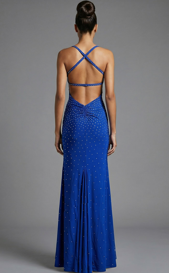 Back view of fitted evening gown with crisscross straps, open back, and scattered crystal embellishments