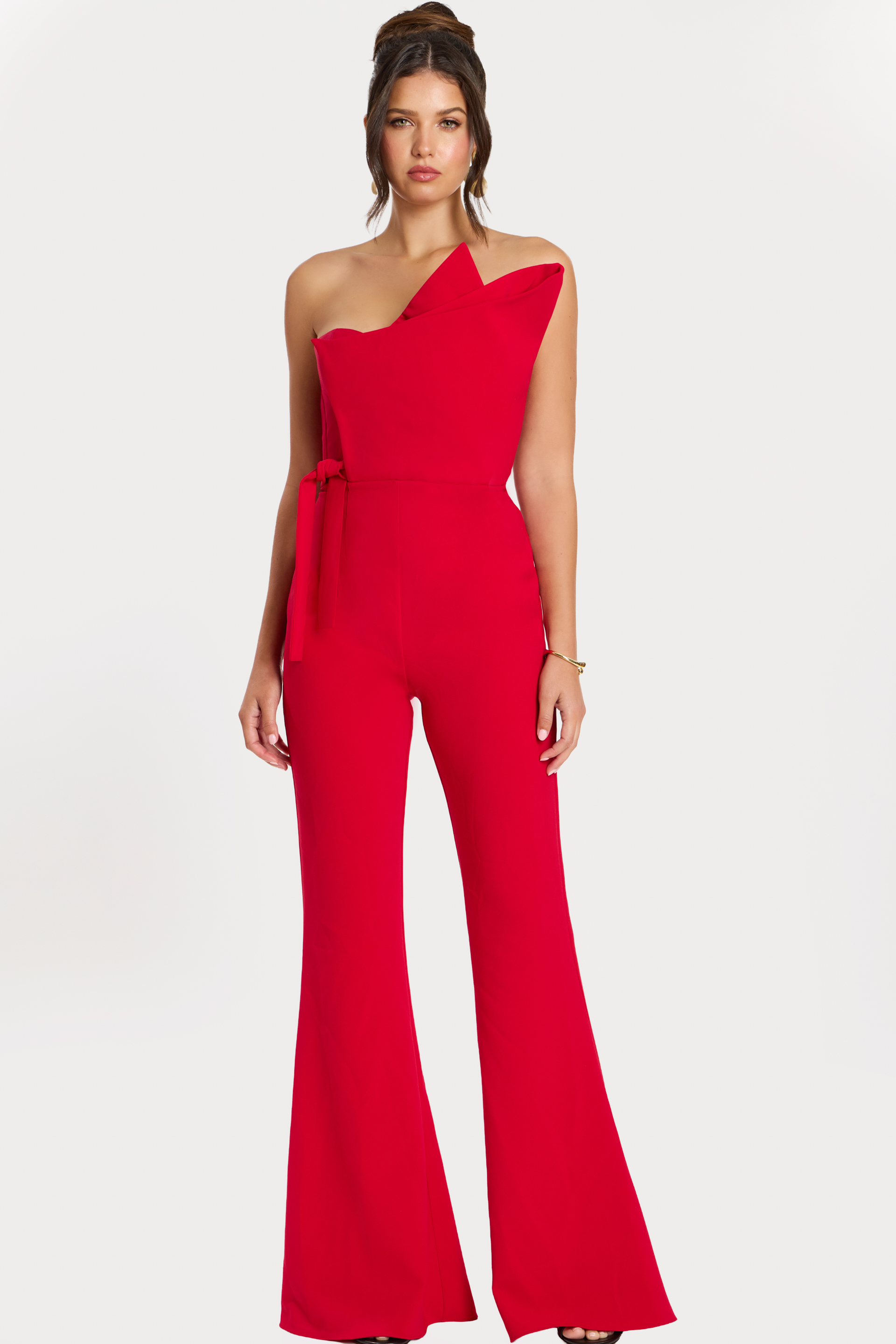 Front view of red one-shoulder structured jumpsuit with flared legs