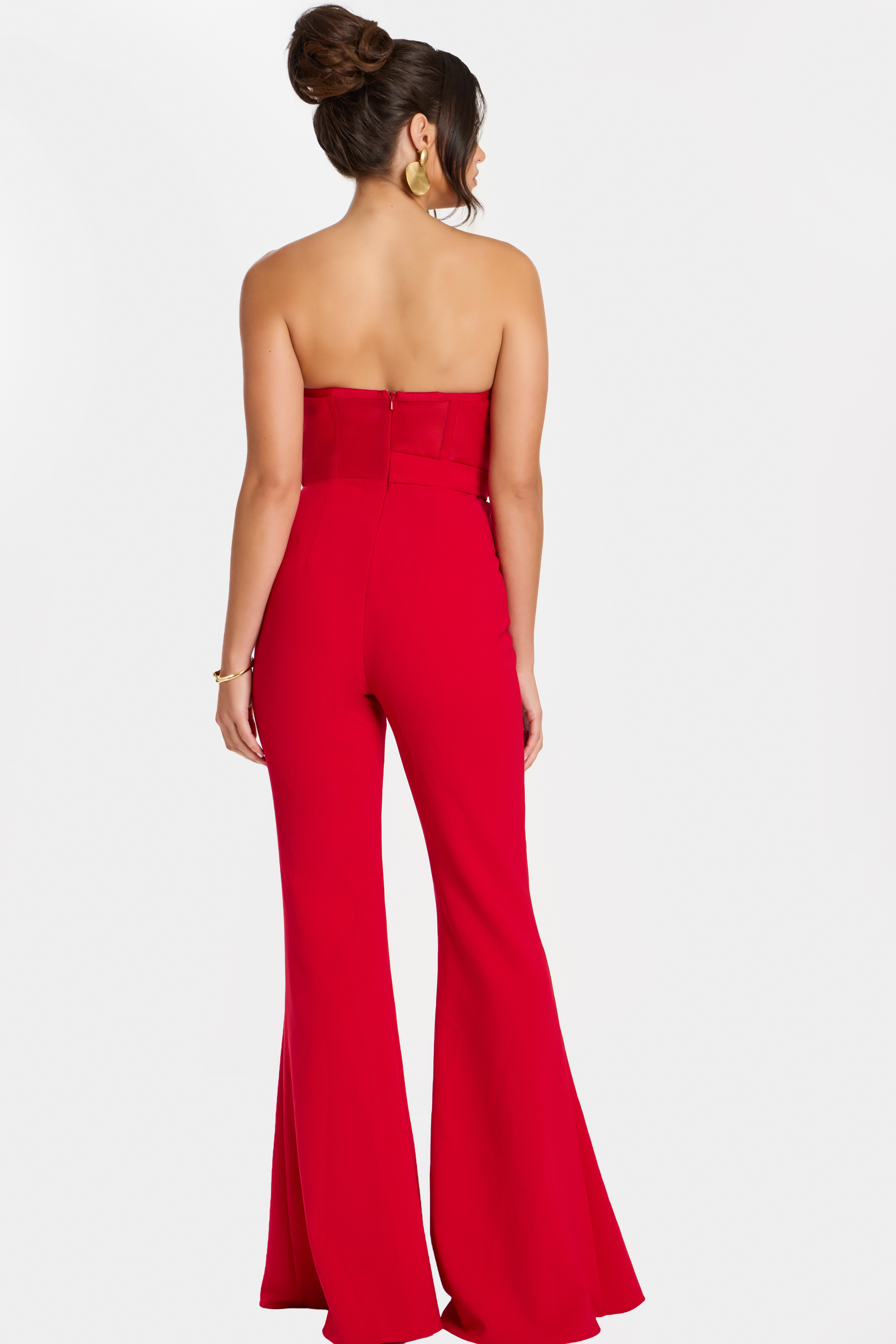 Back view of strapless red flared-leg jumpsuit with center zipper