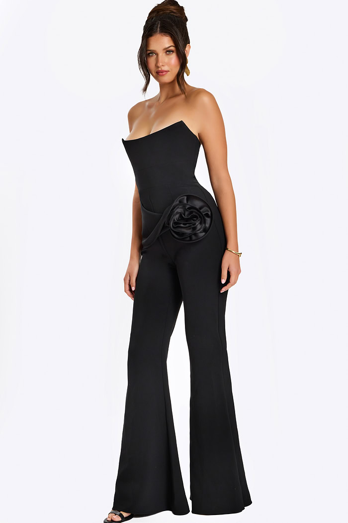 Strapless black jumpsuit with satin rosette detail at the hip