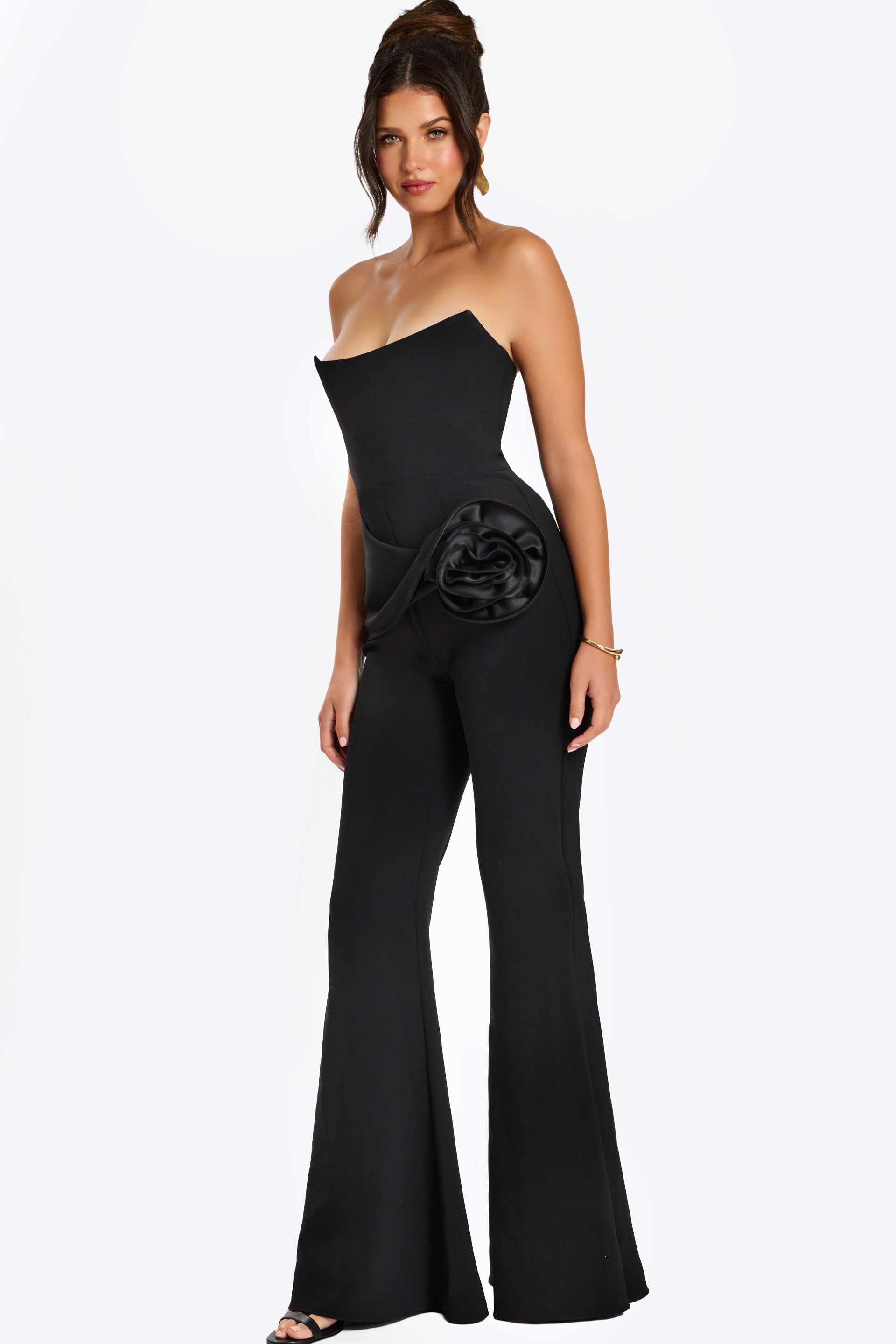 Strapless black jumpsuit with satin rosette detail at the hip