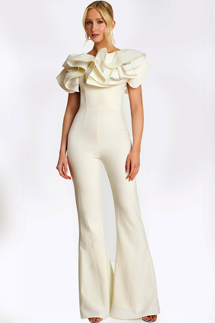 Elegant white jumpsuit with dramatic ruffled shoulders and pearl safety pin accents