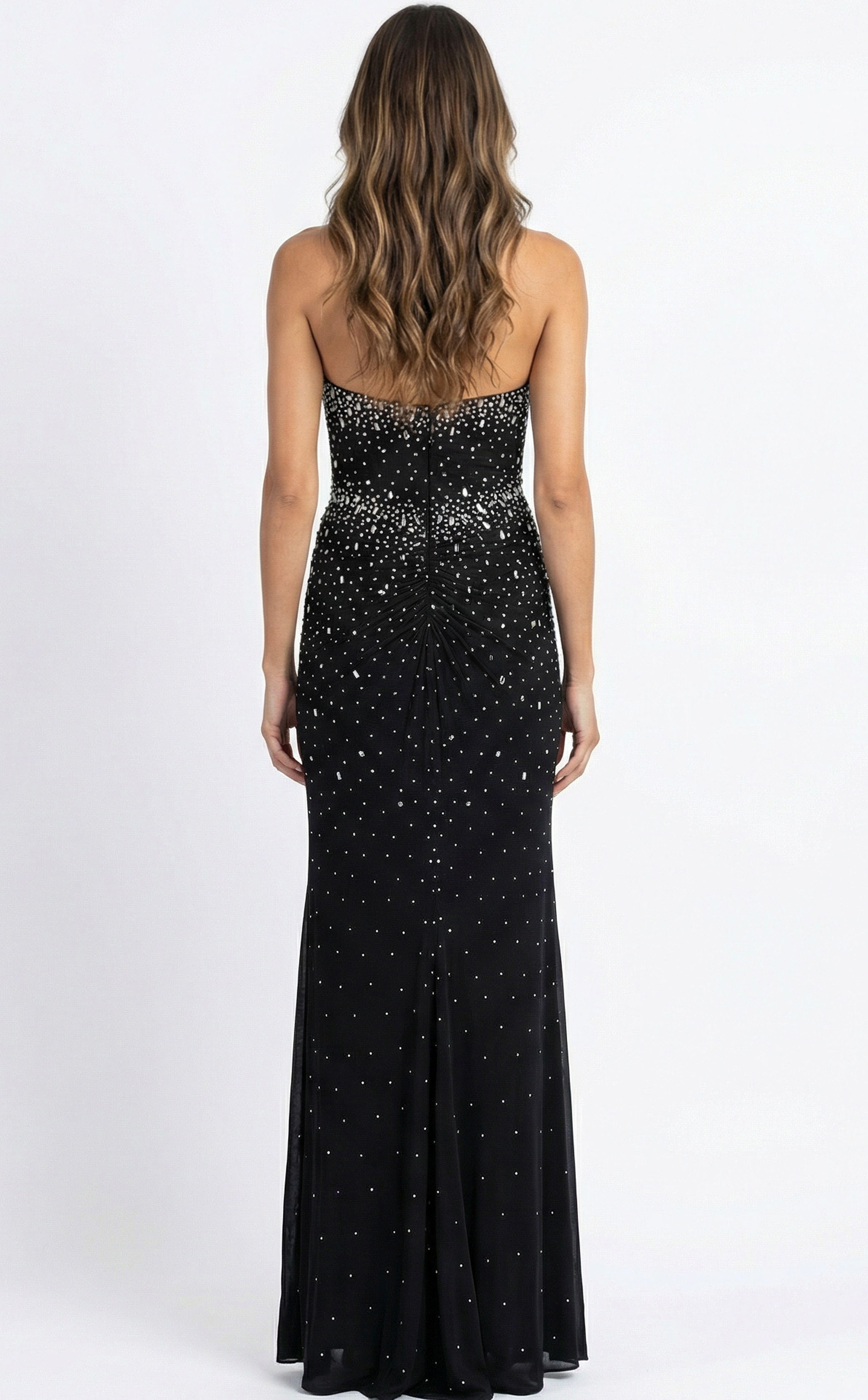 Back view of fitted halter gown with open back, gathered detailing, and floor length silhouette