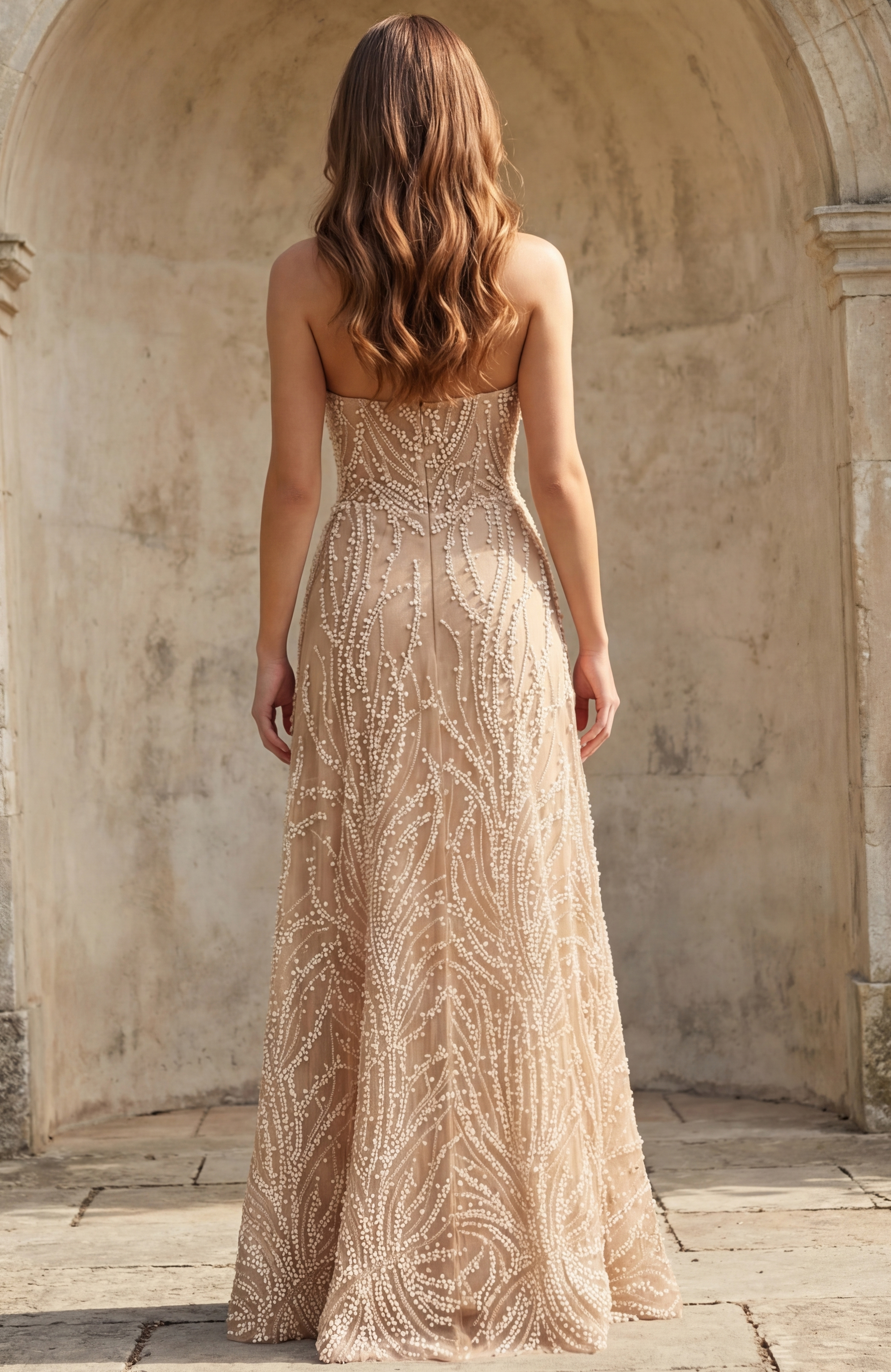 Back view of bridal gown with sheer fabric and intricate beadwork