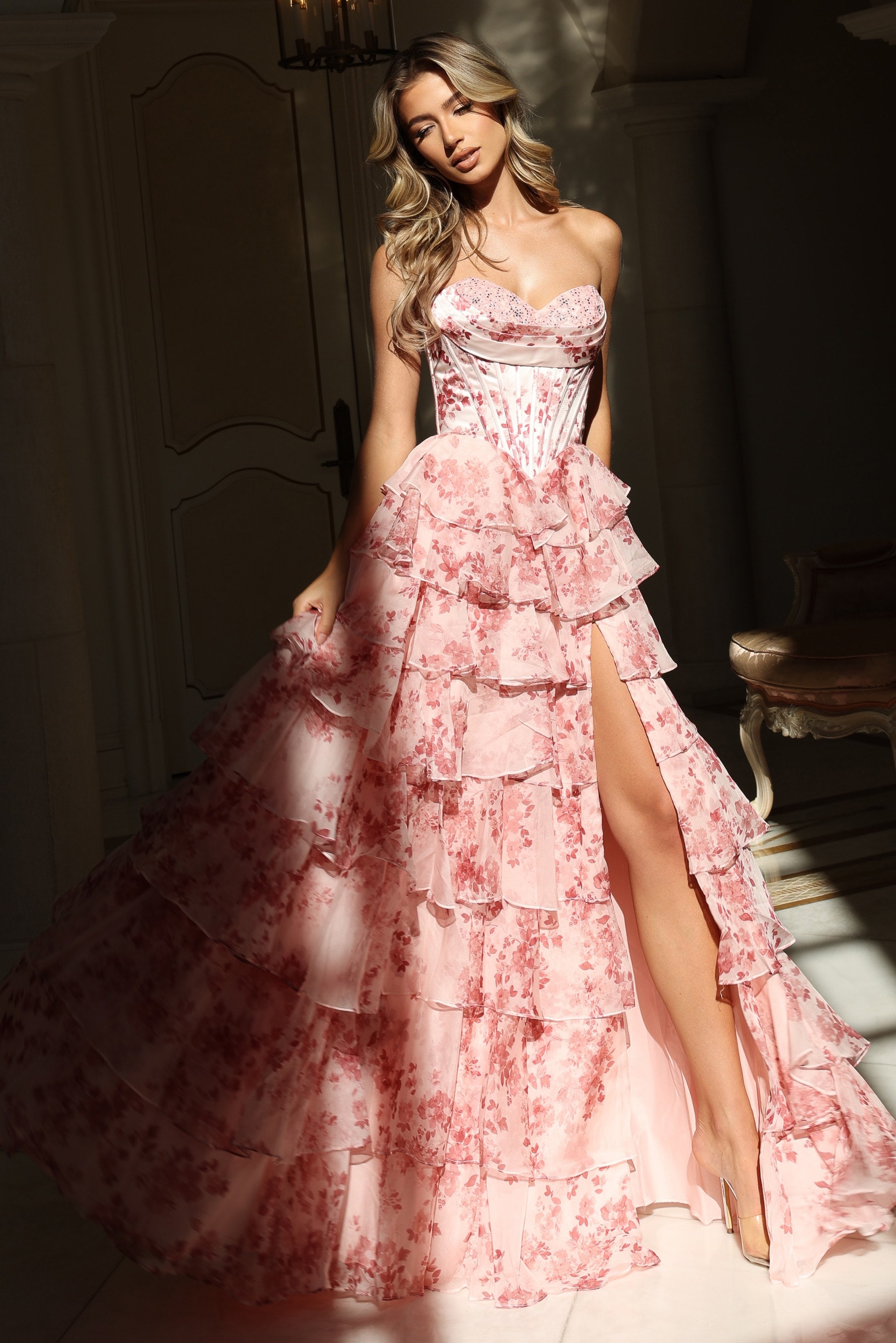 Elegant printed gown with cascading ruffled skirt and fitted corset