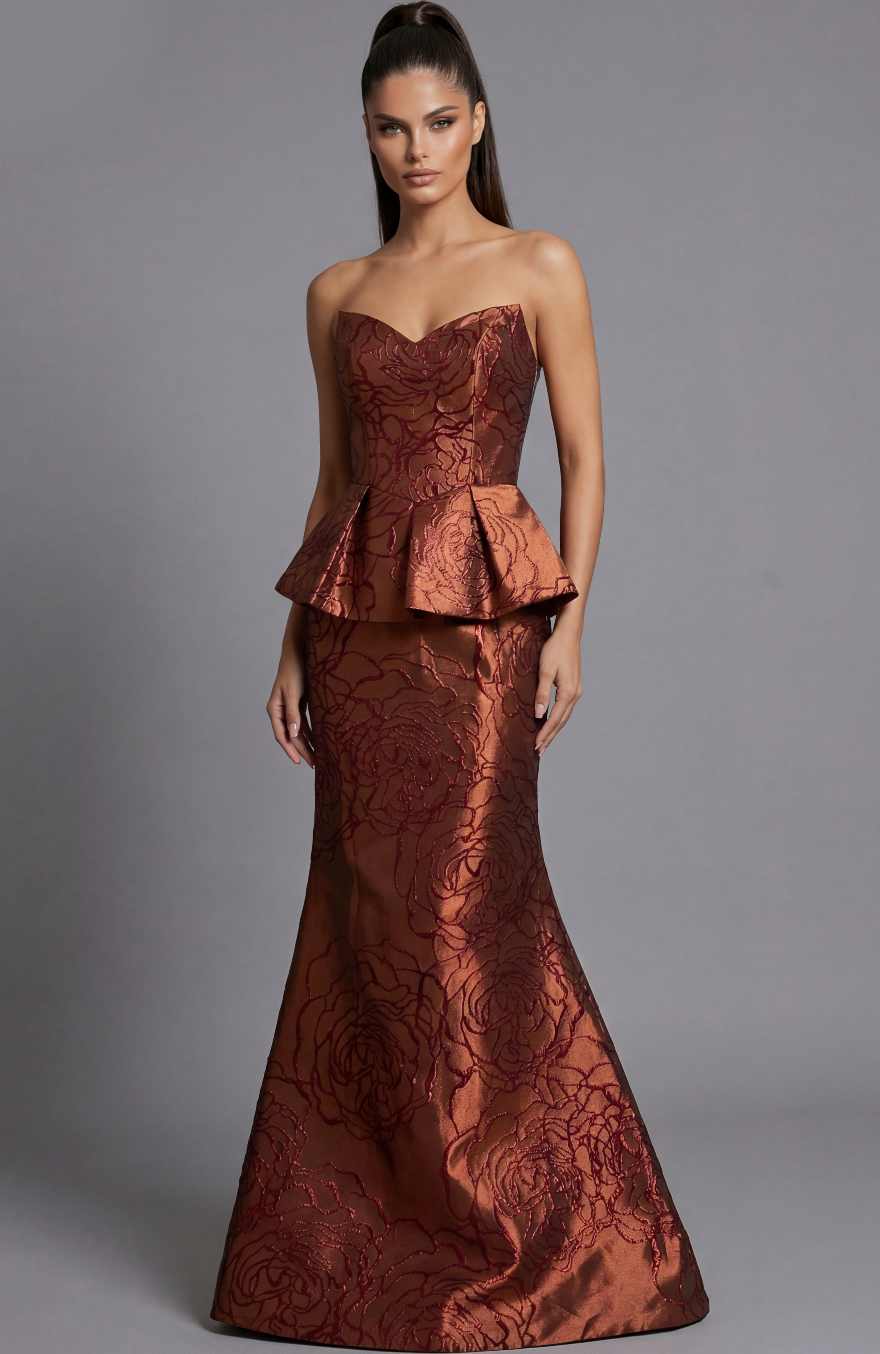 Strapless brocade evening gown with structured bodice and peplum waist