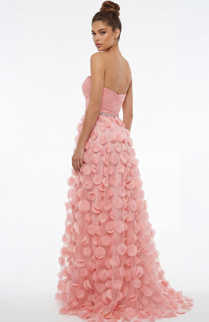 Back view of strapless gown with ruched bodice, beaded waist, and flowing skirt covered in soft circular appliqués