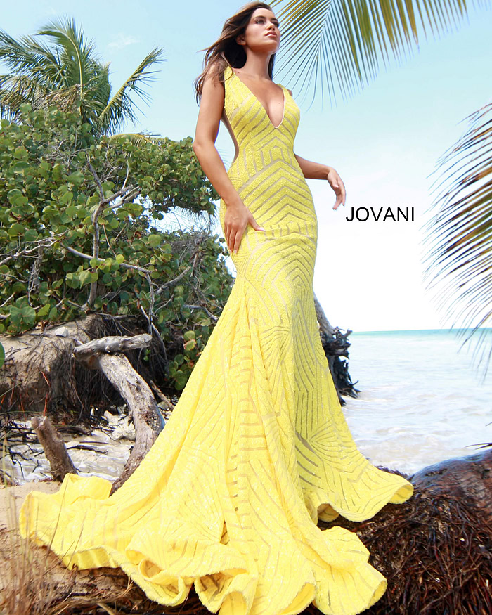 Model wearing Jovani 59762 yellow gown with a mesmerizing mermaid silhouette and sequins.
