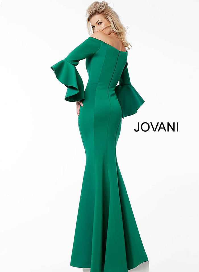 Model in Jovani 59993 Green gown with mermaid silhouette and off-shoulder neckline.