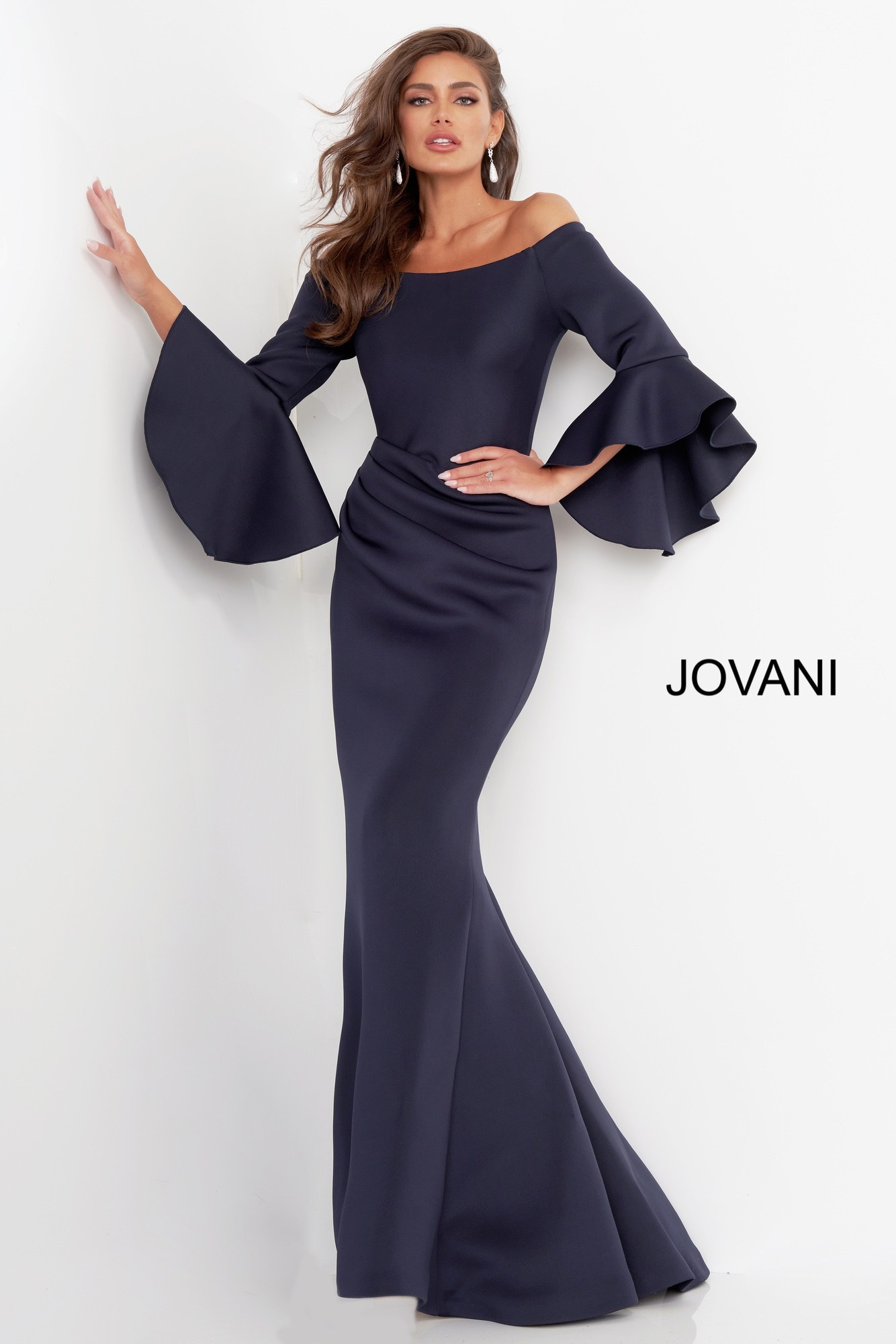 Model wearing Jovani 59993 Navy gown with elegant bell sleeves.