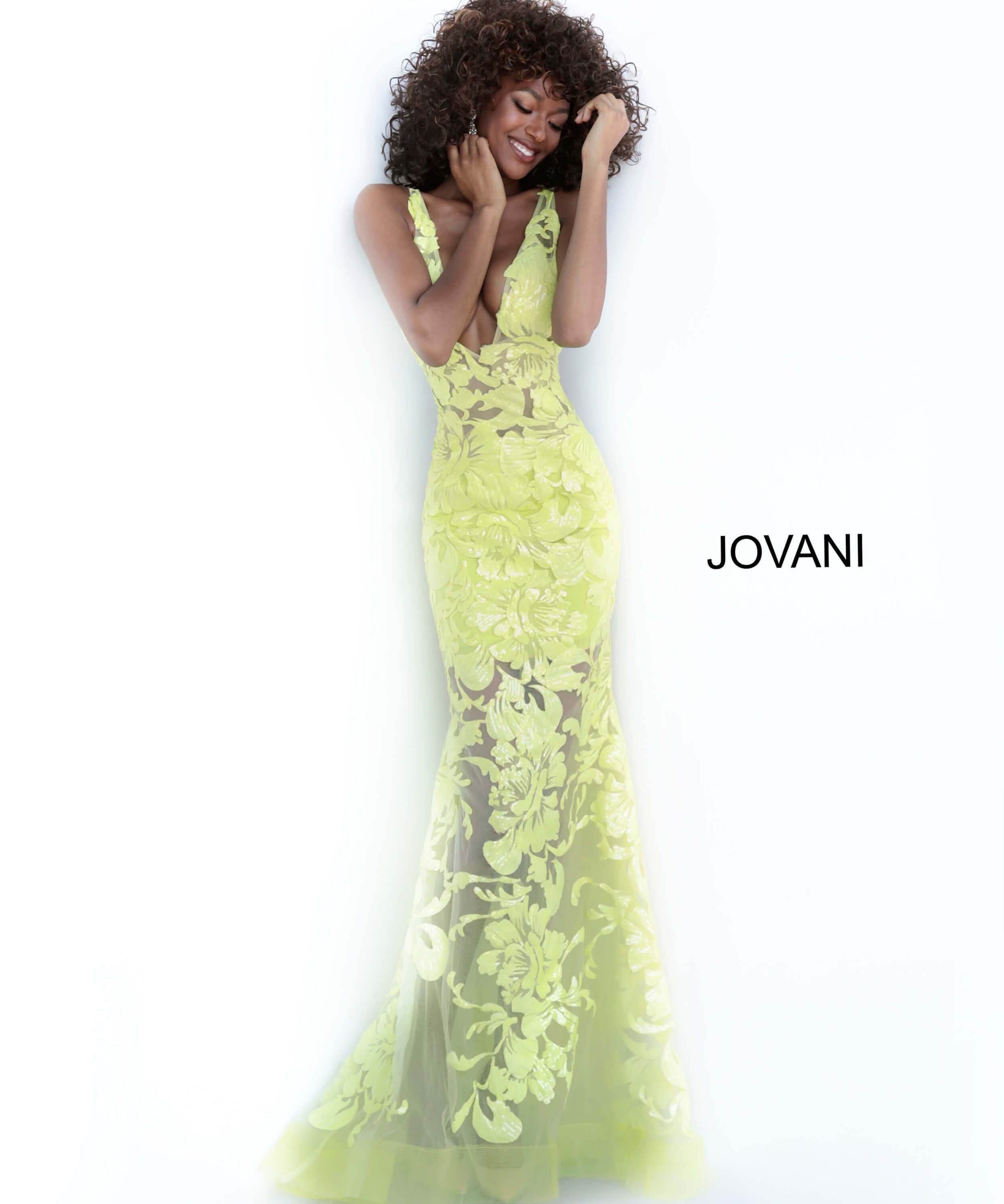 Model in Jovani 60283 yellow floral lace mermaid gown.