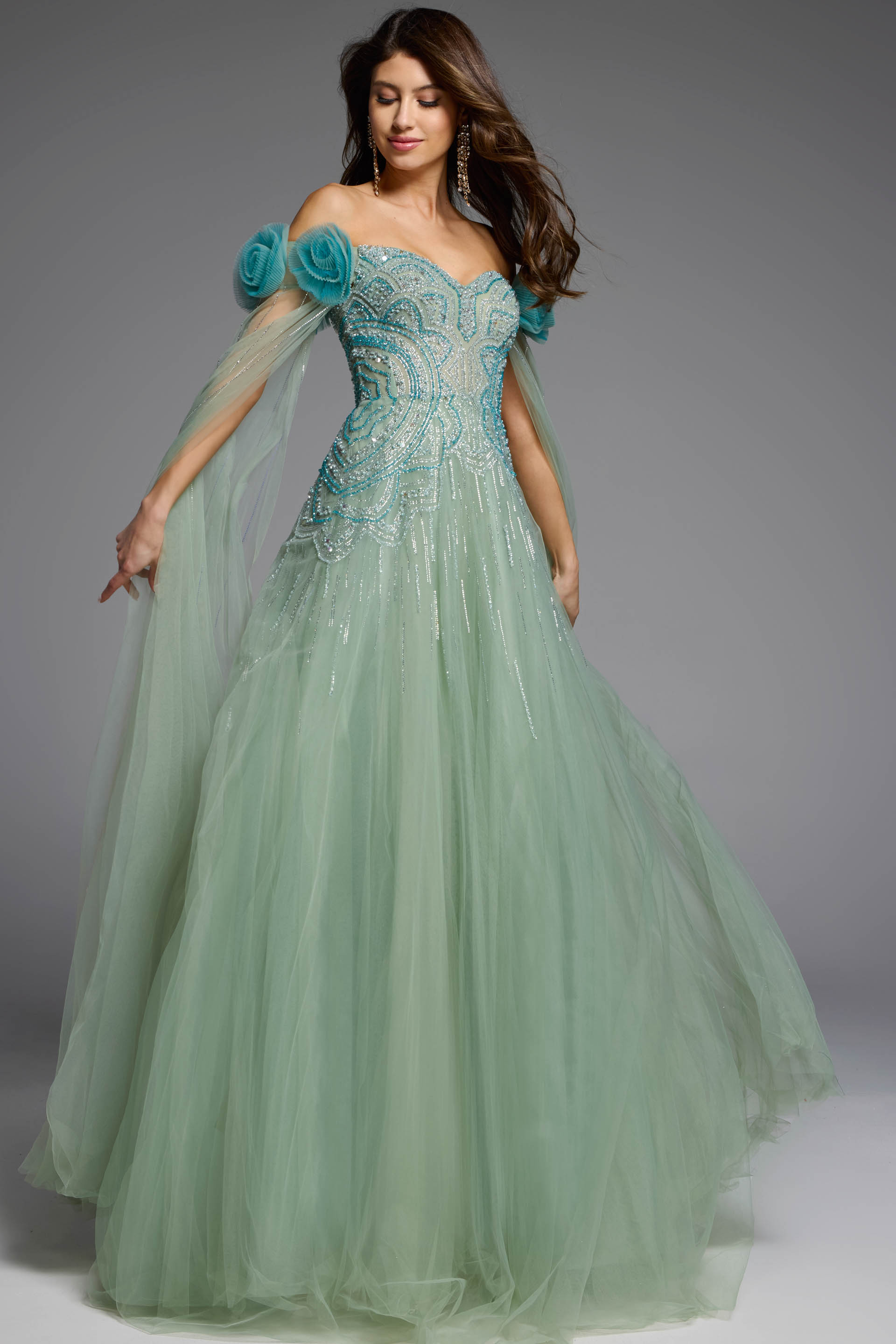 Off-the-shoulder green gown with delicate tulle cape detailing