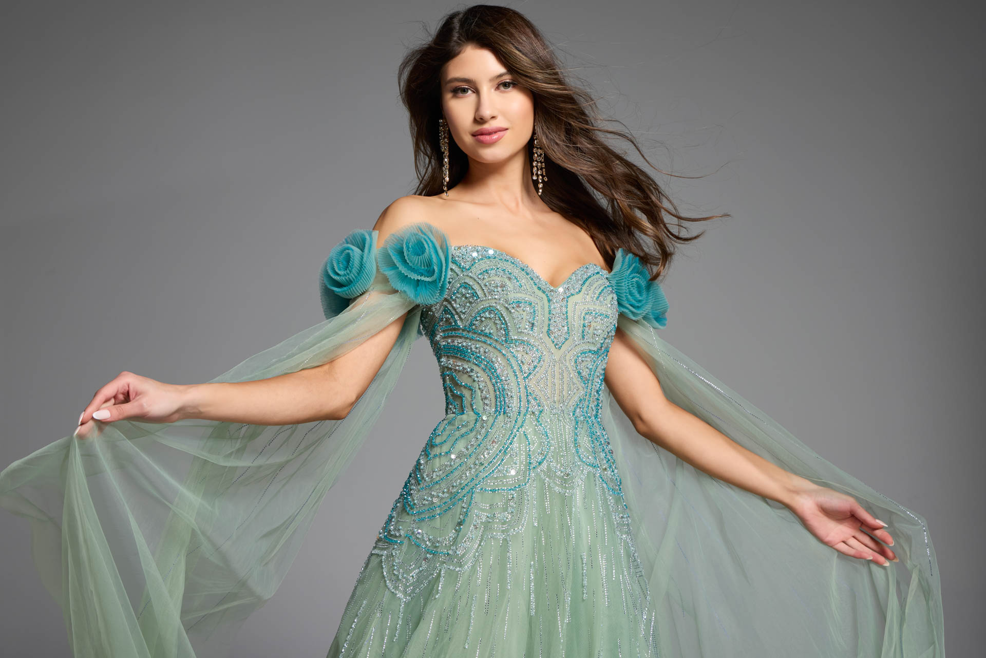 Close-up of floral accents on a green off-the-shoulder gown