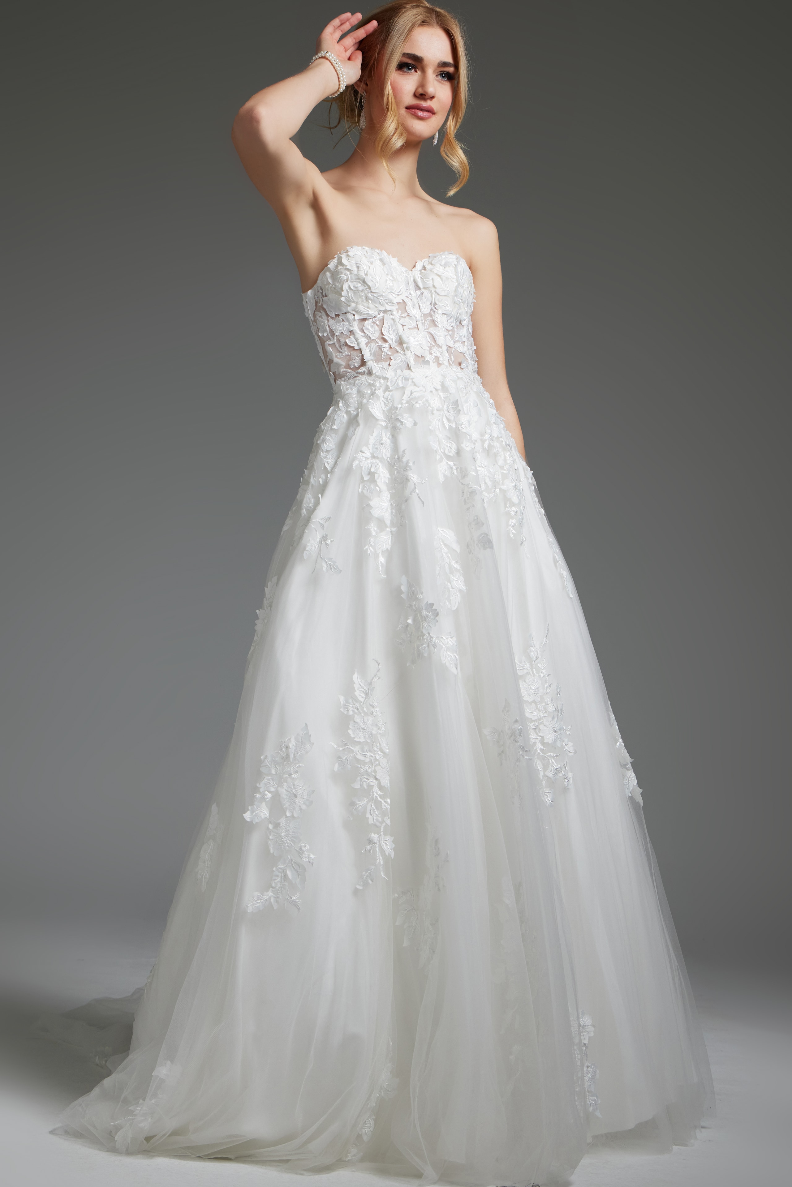 Model in Jovani JB05361, ivory gown with a flowing skirt and delicate embroidered bodice.