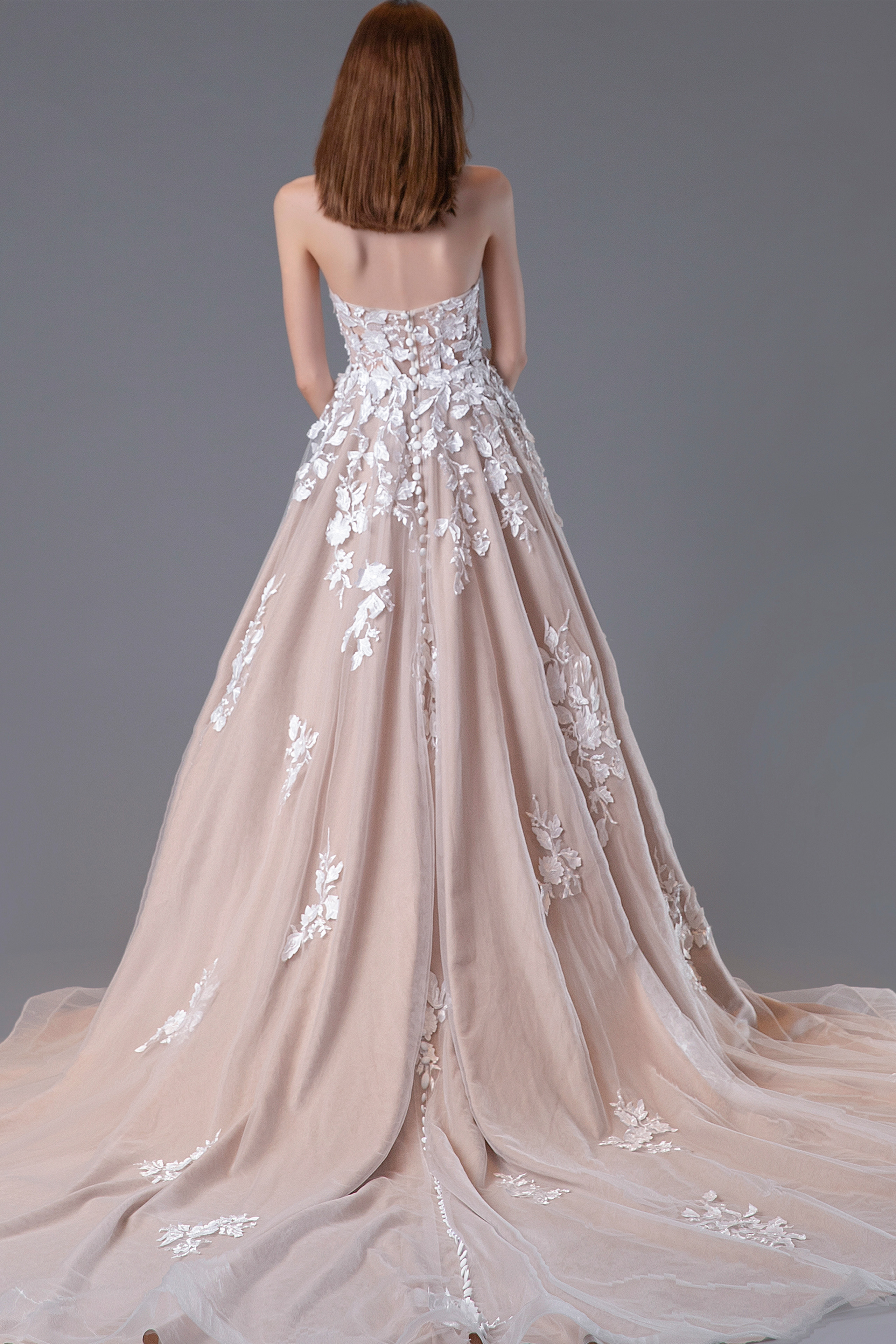 Back view of Jovani JB05361, showing intricate embroidery and flowing train in ivory.
